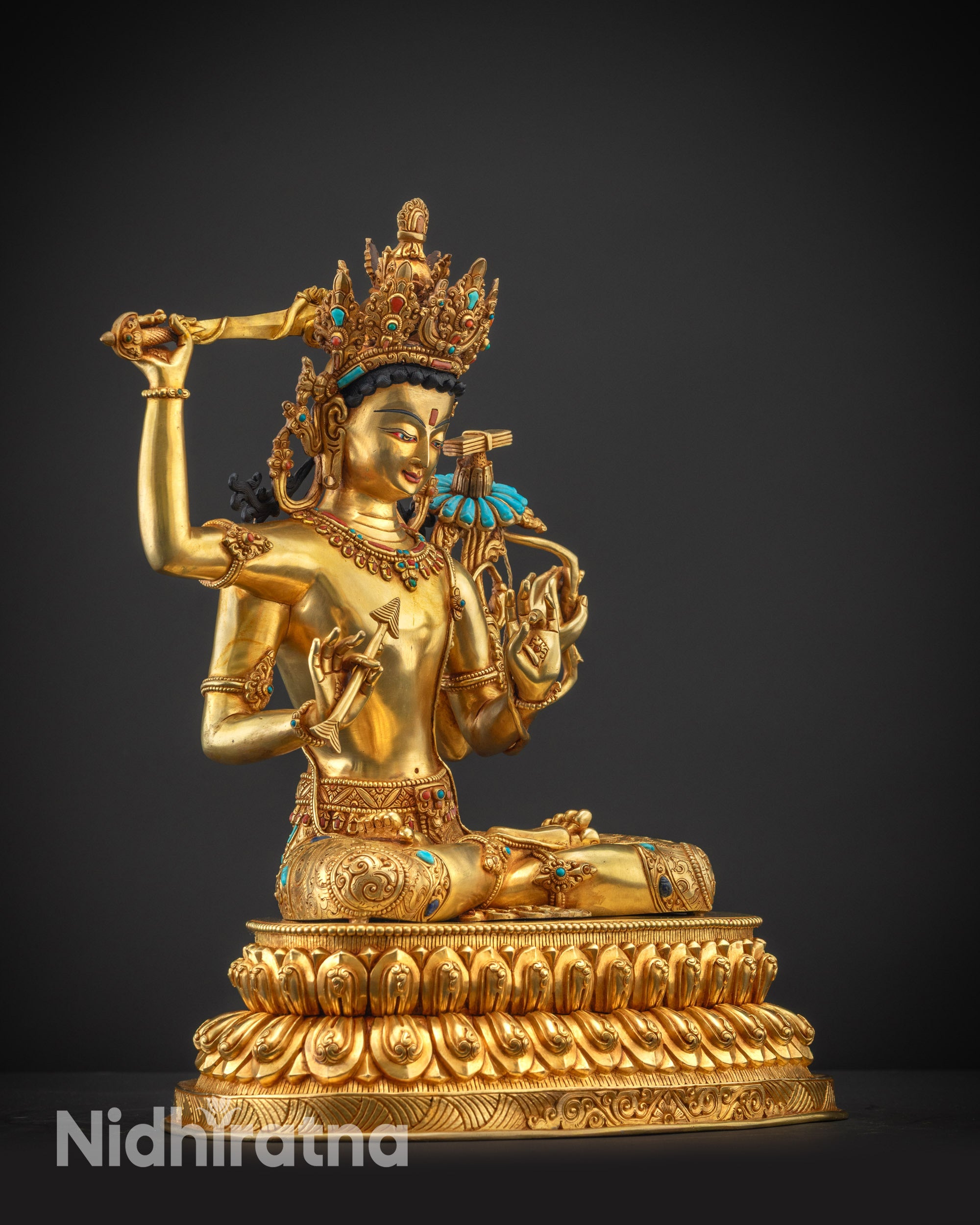 Regular side right view of Maha Manjushri statue with flaming sword and intricate carvings.