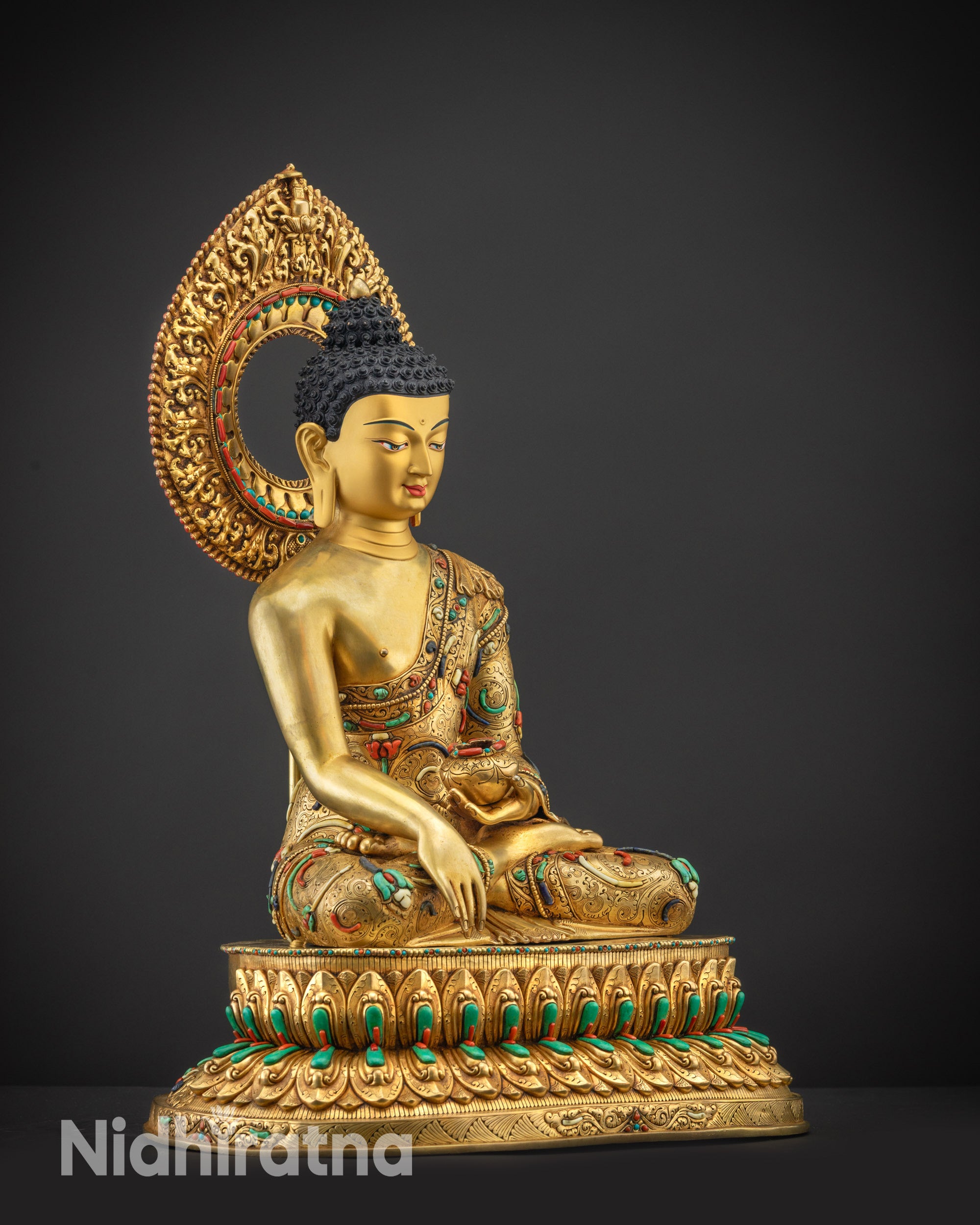 Regular side right view of Shakyamuni Buddha statue seated in lotus pose on lotus base