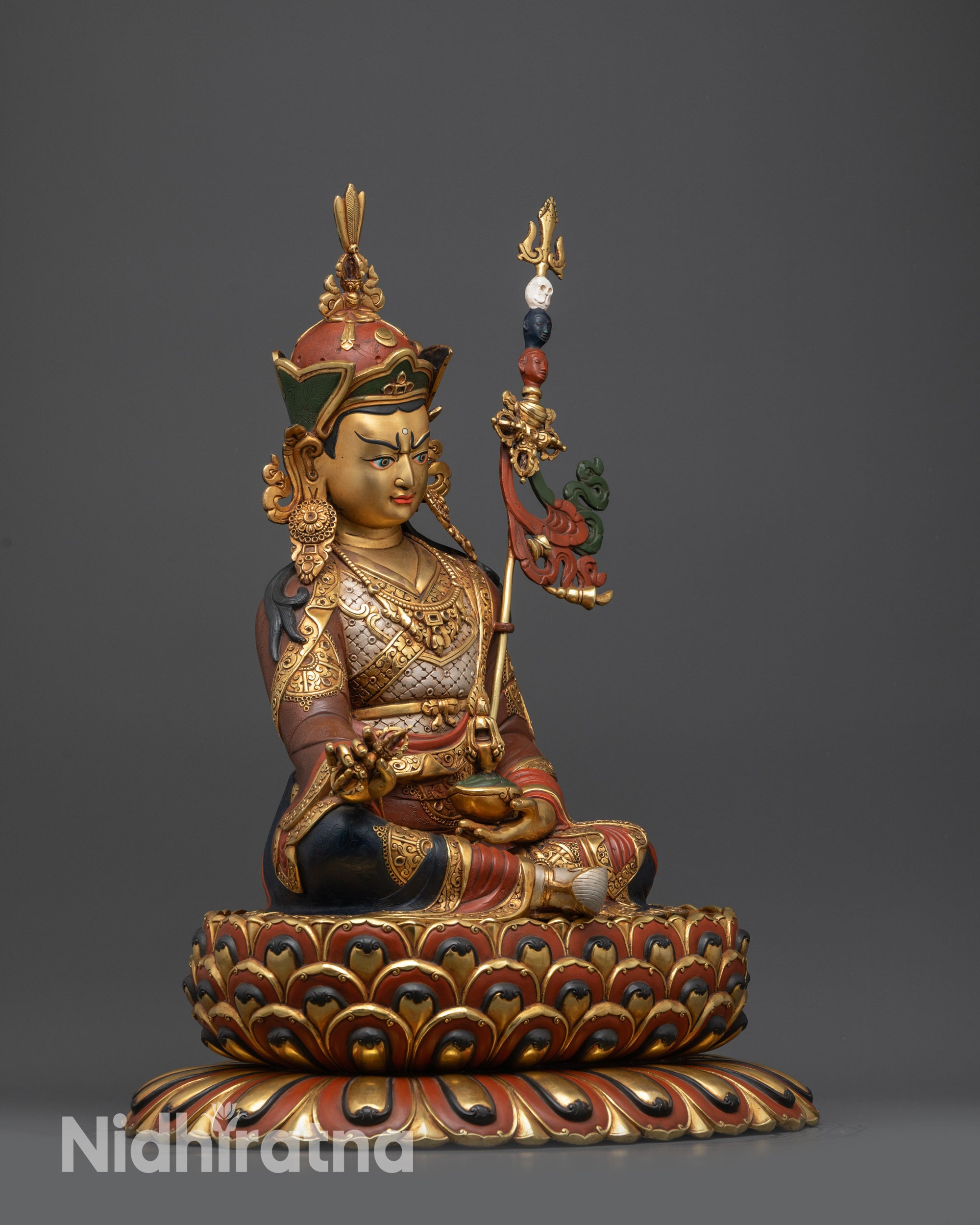 Regular side view of Guru Rinpoche gold-gilded jewelry, trident, and ornate lotus pedestal carvings