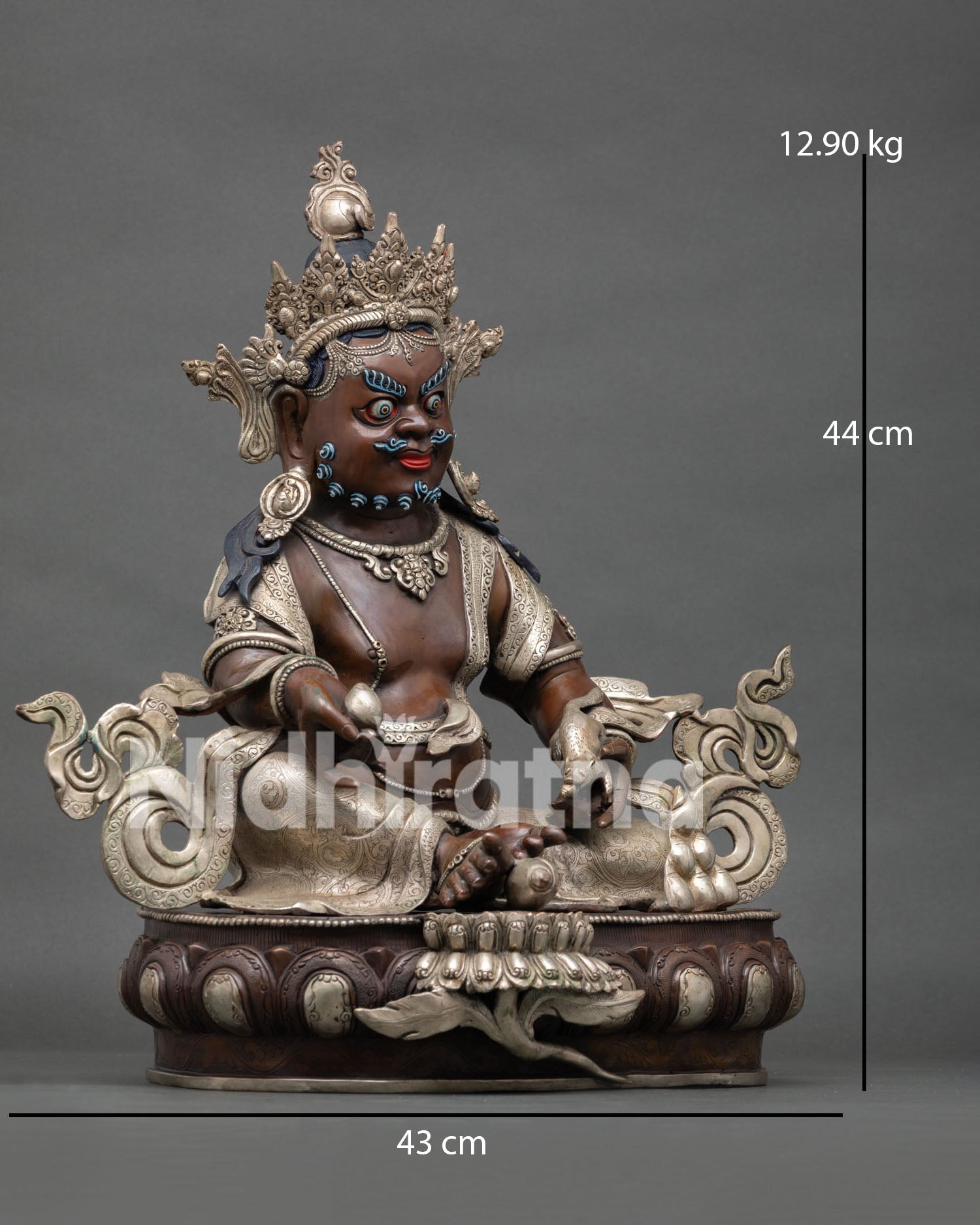 Right side view of Dzambhala statue holding nakula mongoose and citron fruit on lotus throne