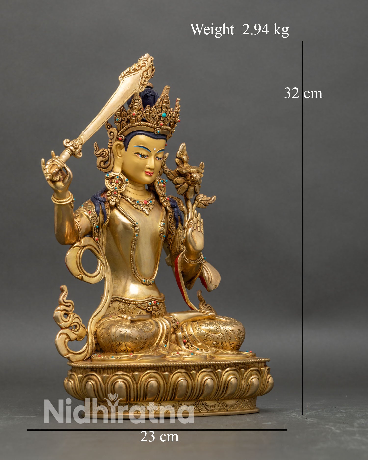 Right profile of Manjushri statue seated on lotus holding sword and scripture lotus
