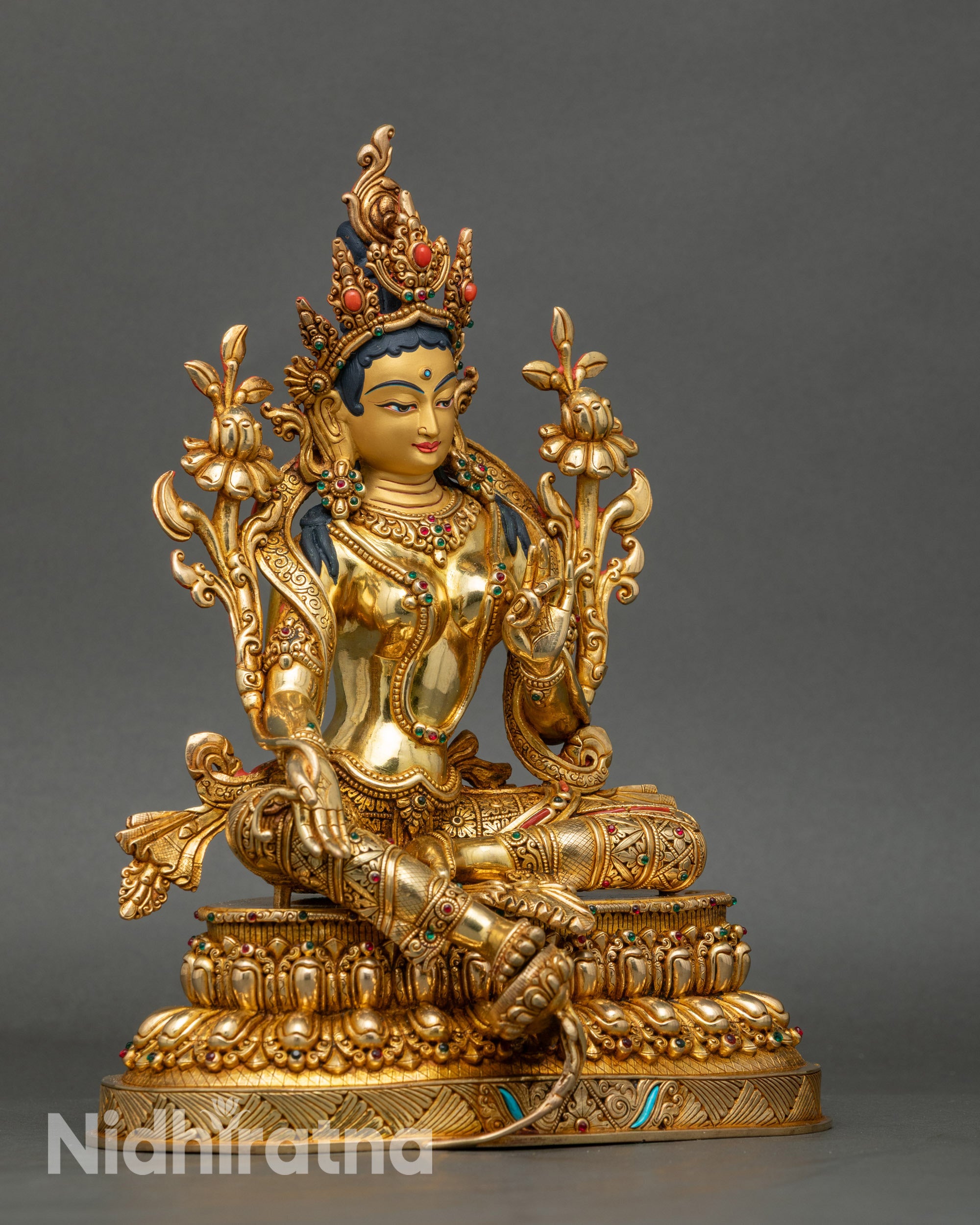 Right profile of Green Tara statue, copper sculpture with radiant gold layers