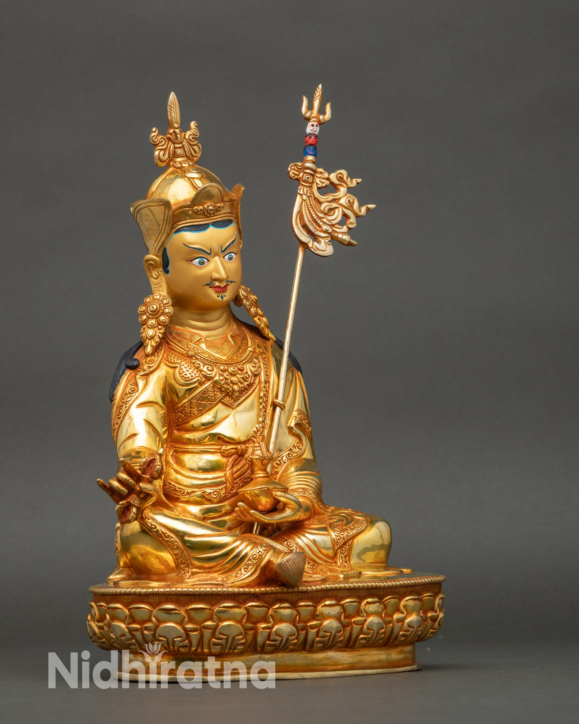 Right profile of Guru Rinpoche with lotus hat and swirling kasaya robe details