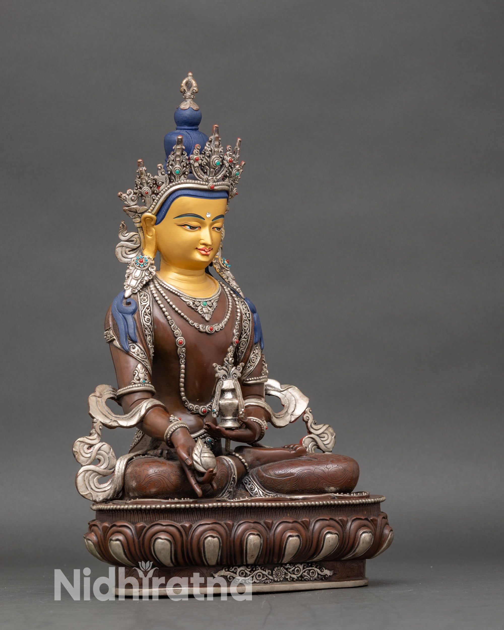 Right profile of Oxidized Kshitigarbha statue seated on carved lotus pedestal