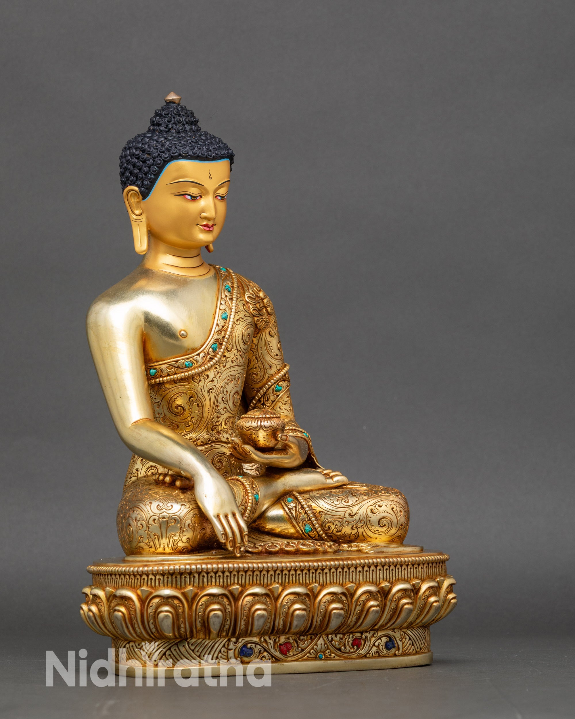 Right profile of Shakyamuni Buddha statue seated in lotus posture on ornate base