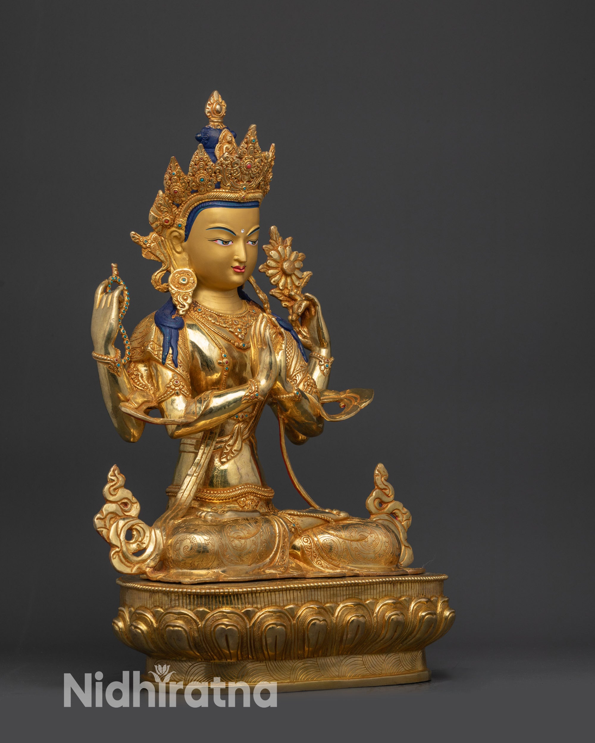 Right side view Chenrezig statue with dharma wheel, deer carvings, and lotus seat