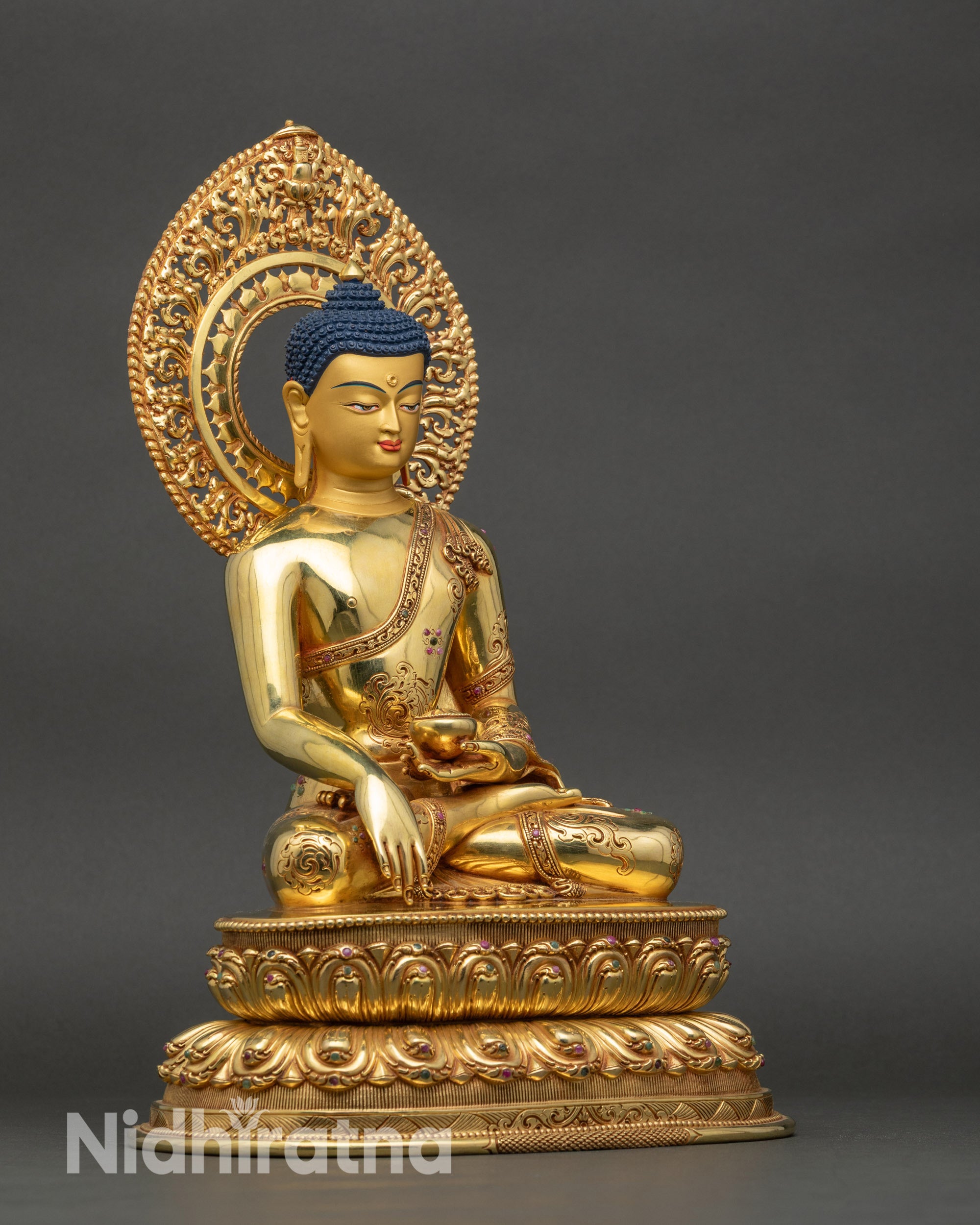Right side view of Buddha statue, handcrafted Nepalese copper with gold highlights