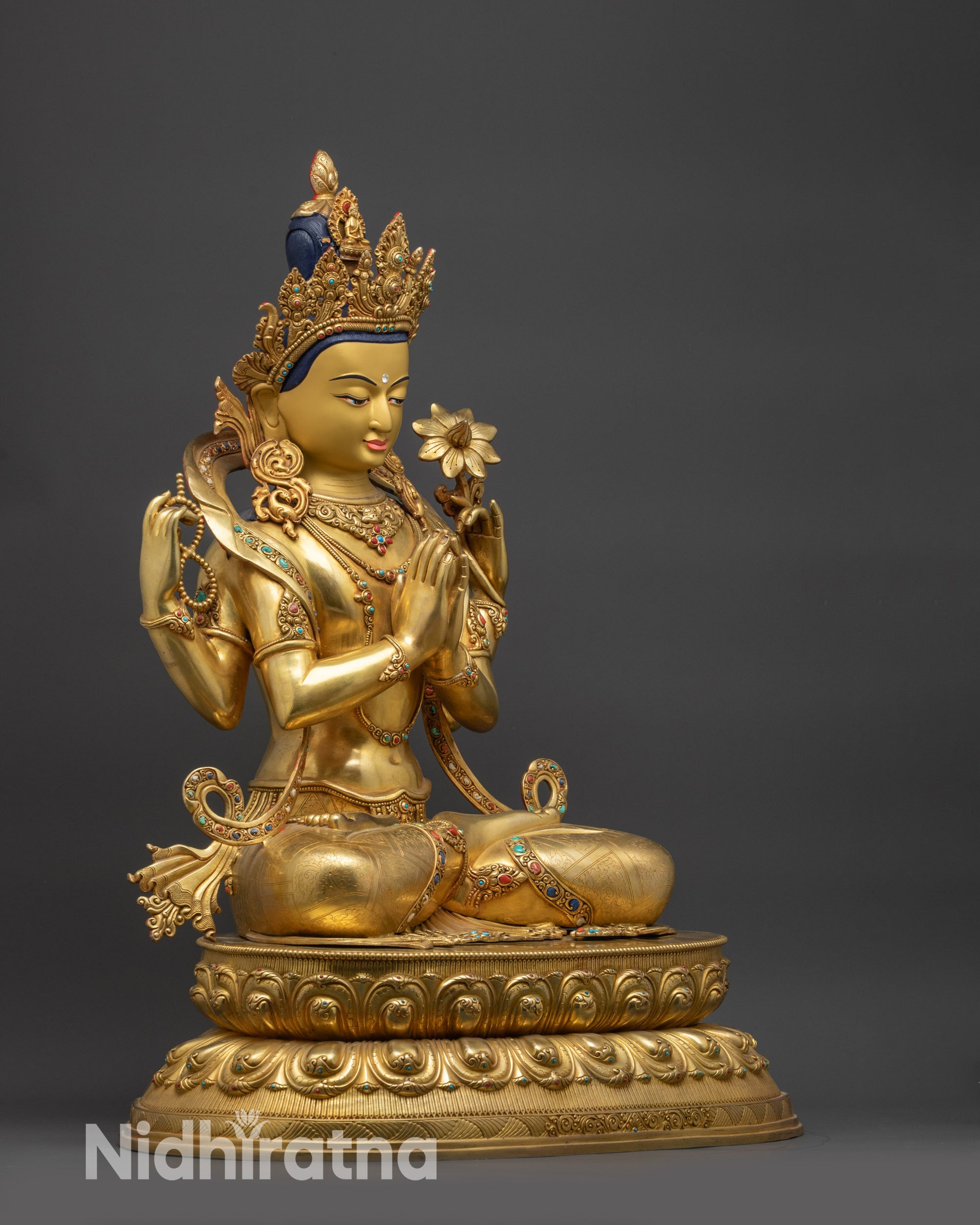 Right side view of Chenrezig Statue holding sacred objects in four hands