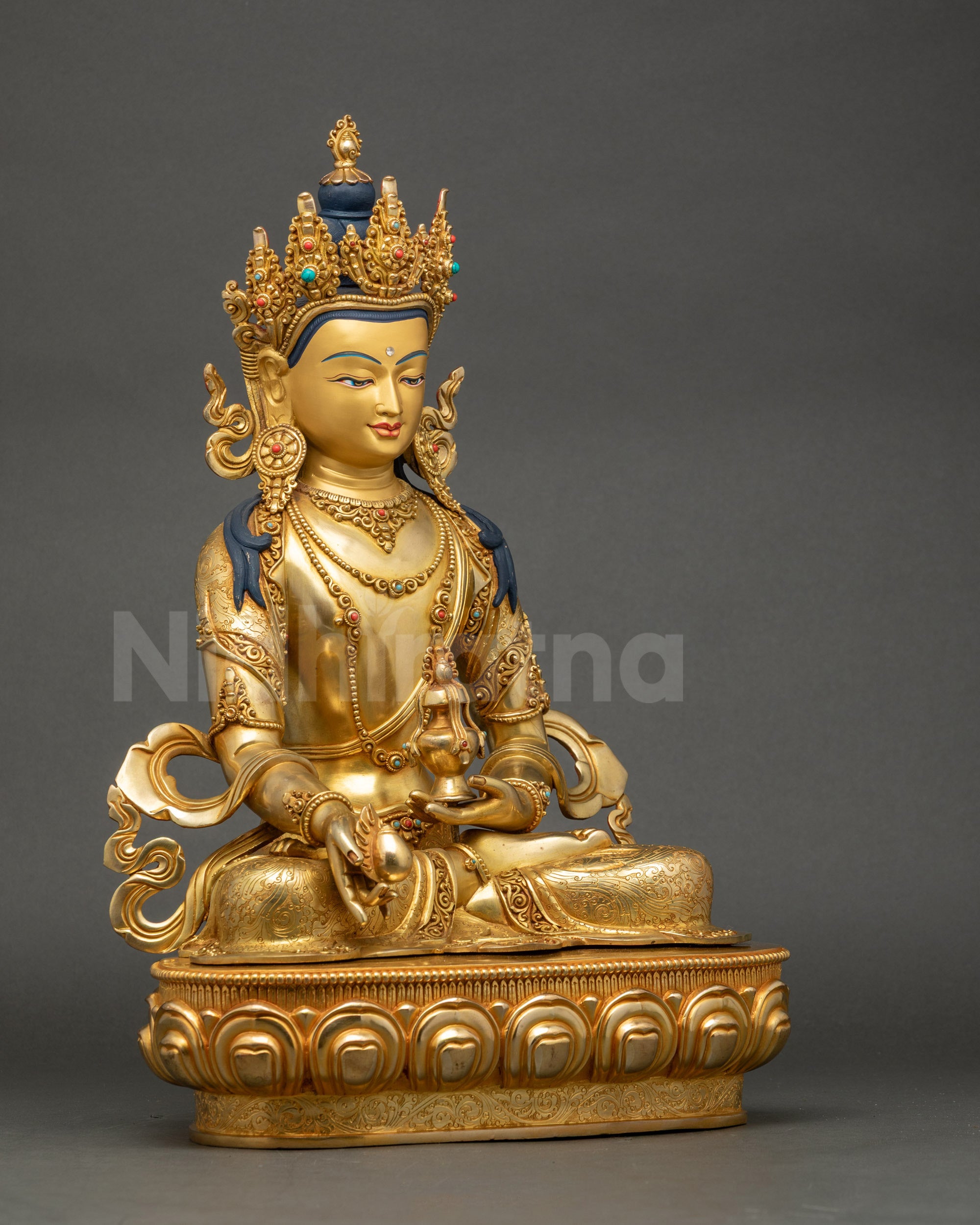 Right side view of Jizo Kshitigarbha statue seated in lotus pose on pedestal