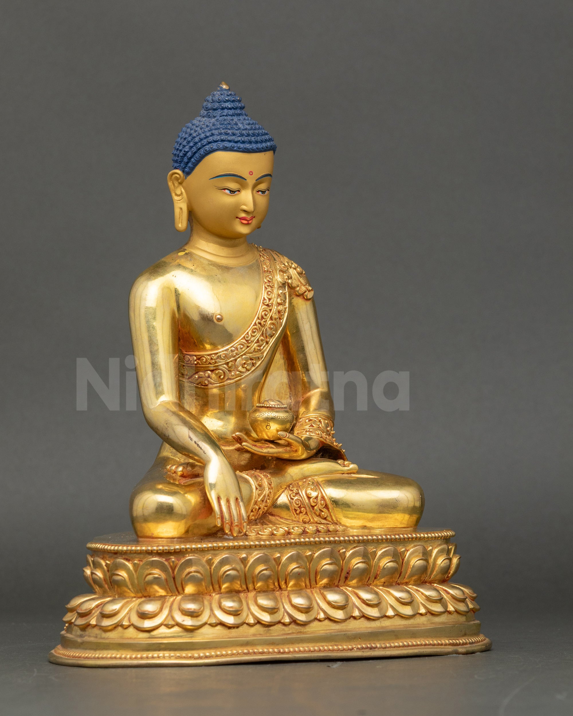 Right side view of Shakyamuni Buddha statue seated on lotus throne in copper and gold