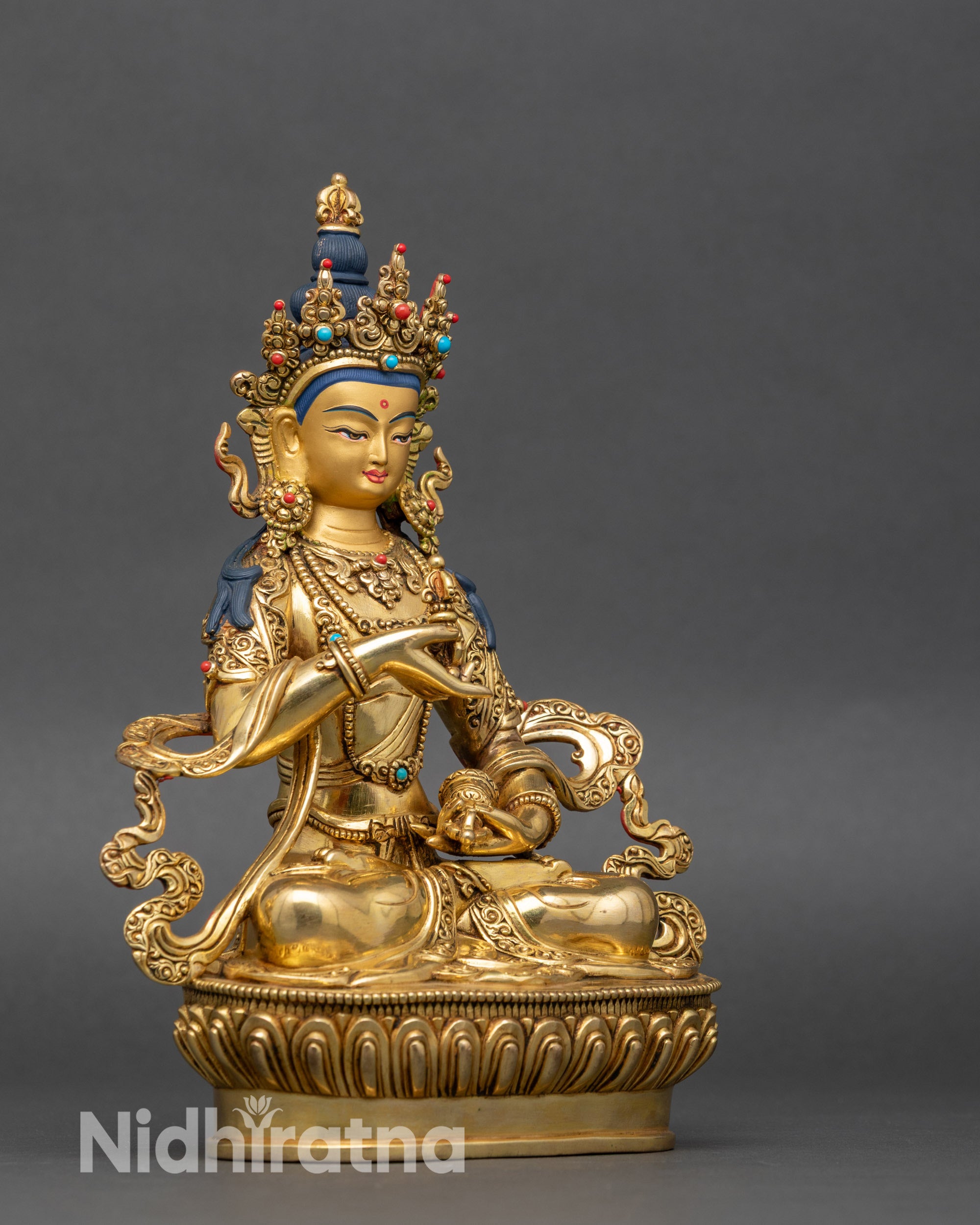 Right side view of Vajrasattva statue on lotus pedestal, copper and gold finish