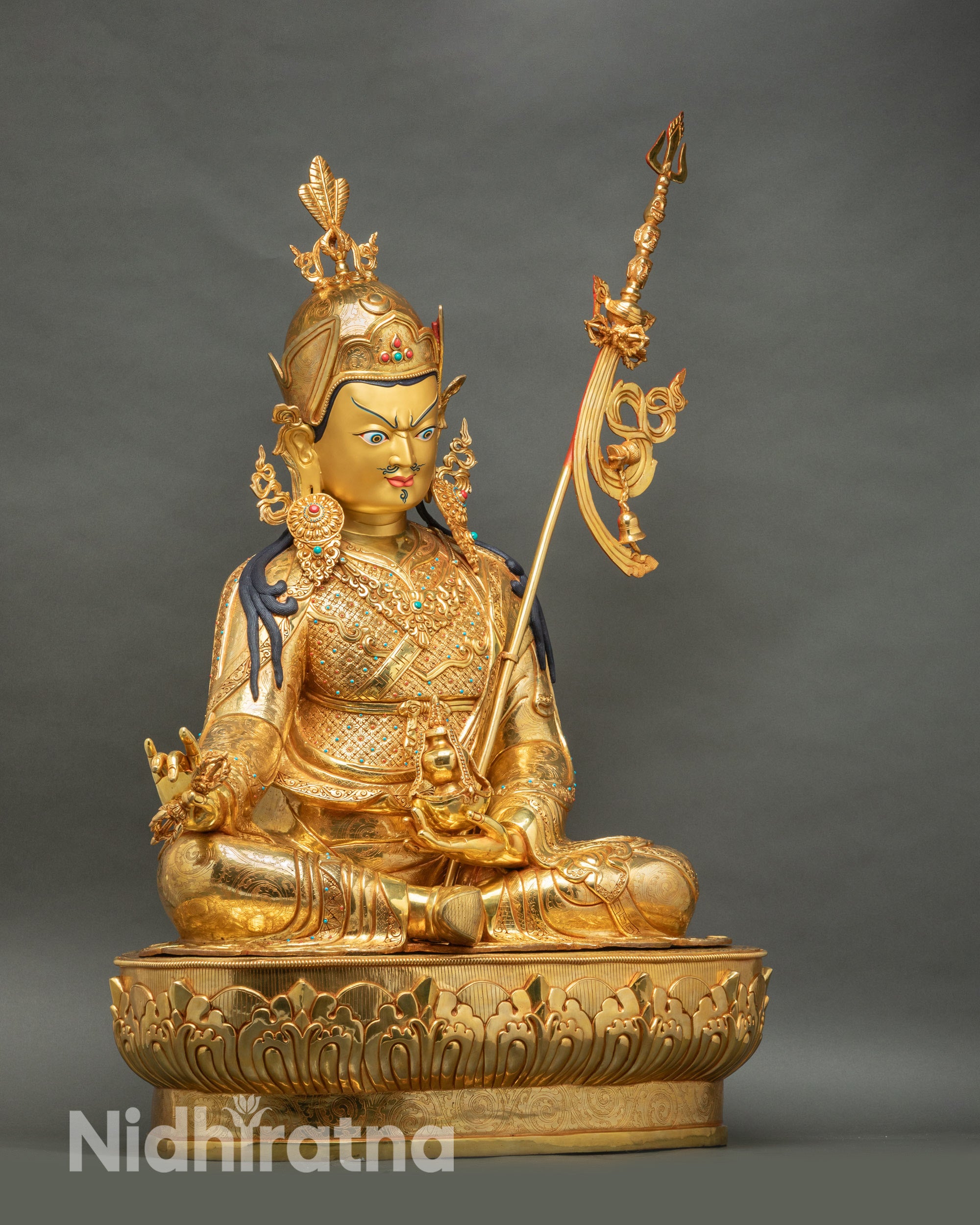 Right side view of life-size Guru Rinpoche statue, khatvanga staff detail, gold fire-gilded copper, handcrafted Nepal