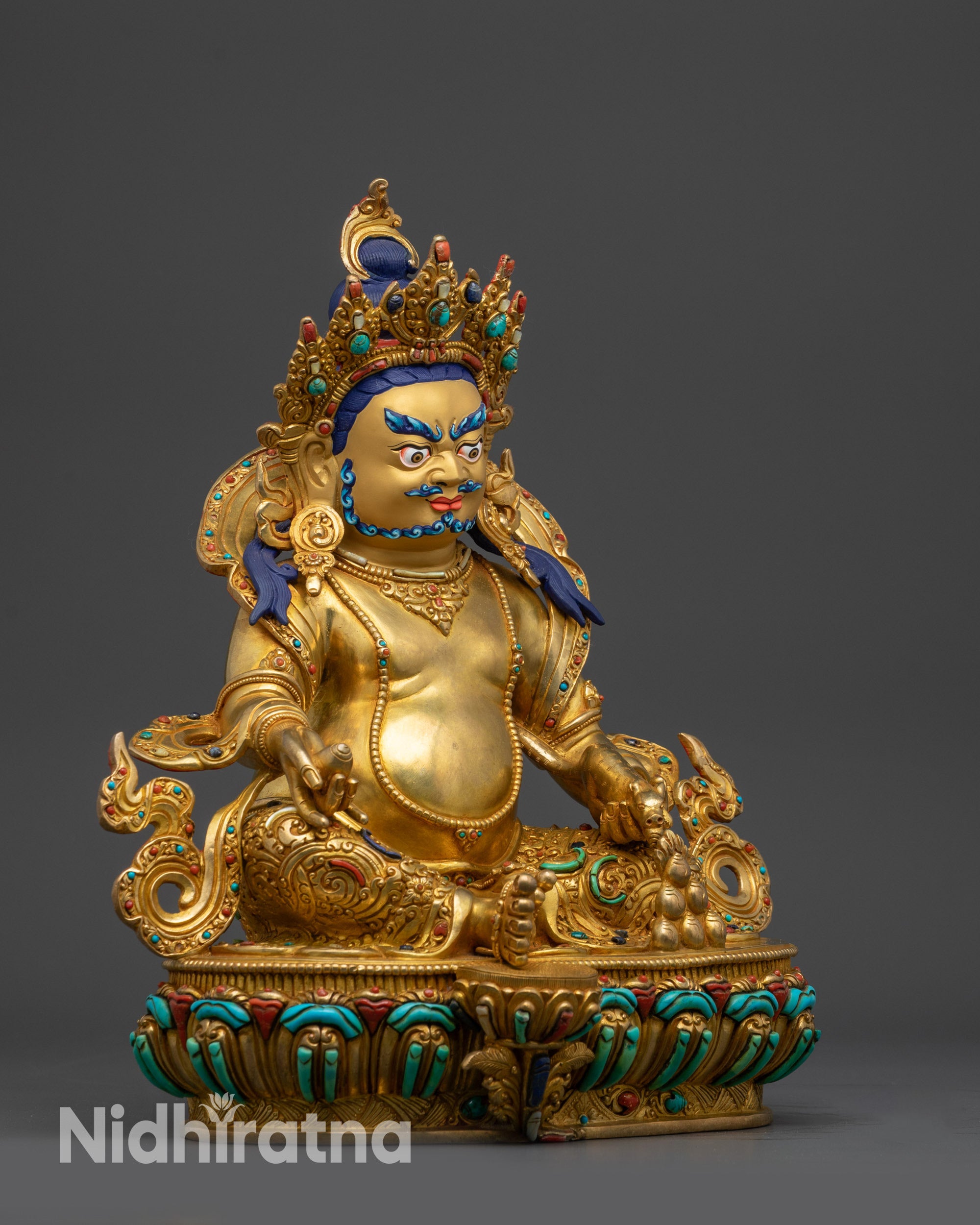 Right view Dzambhala seated in royal ease pose on lotus base with one foot near the shell and holding prosperity symbols