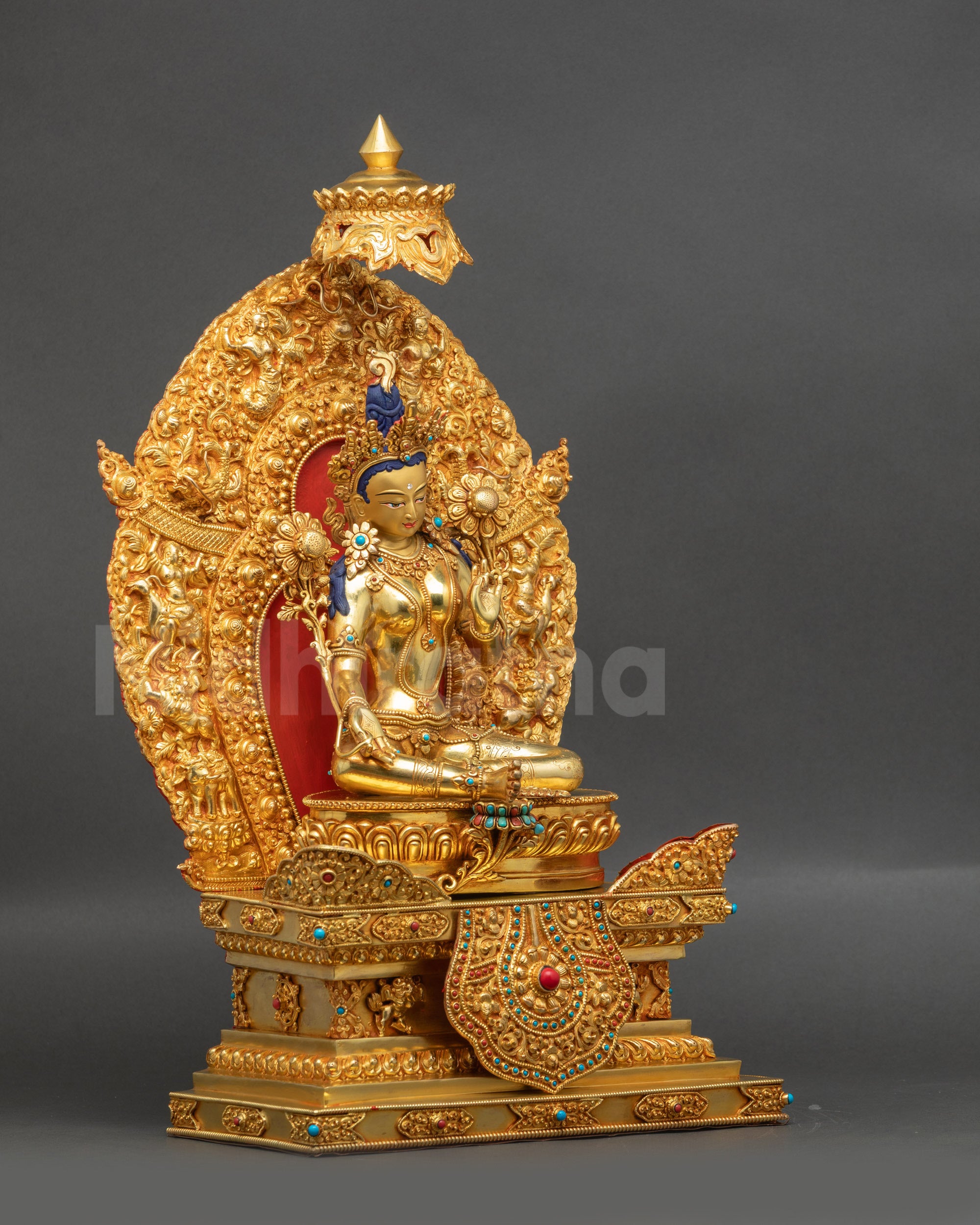 Right view of Green Tara statue on traditional Himalayan deity throne