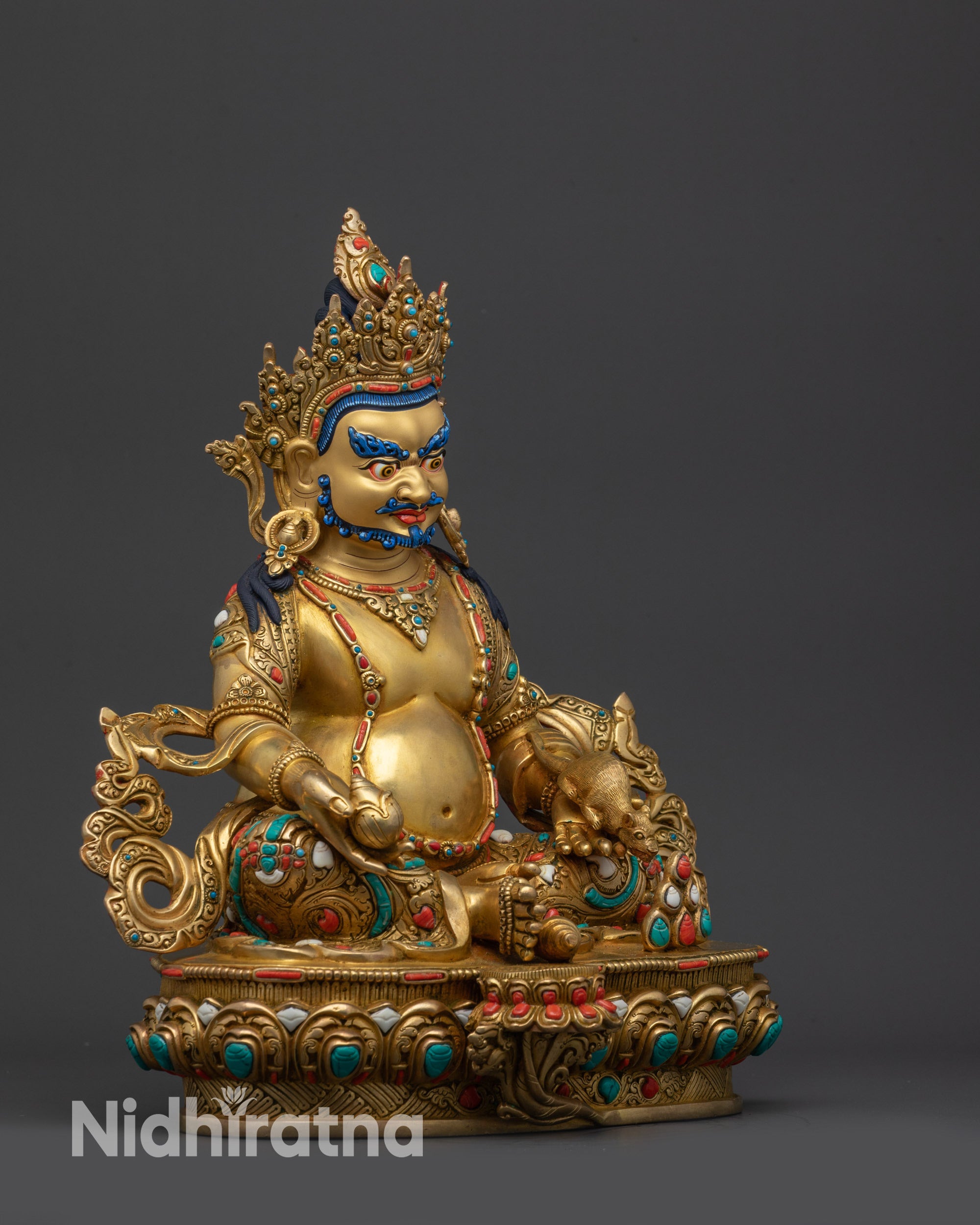 Right view side Dzambhala Statue seated on lotus, foot near shell, royal ease pose