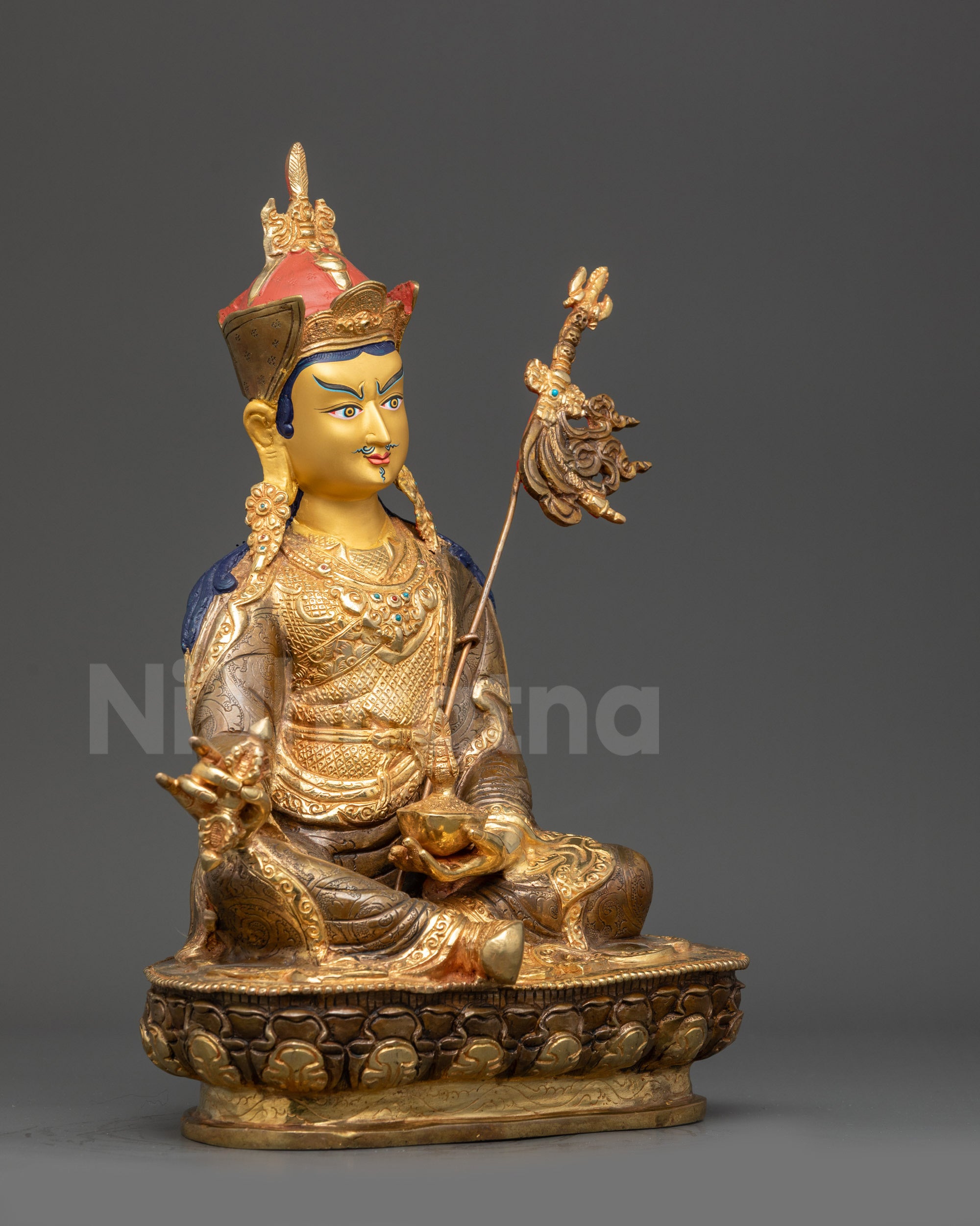 Right view side Guru Padmasambhava seated on lotus throne holding ritual implements