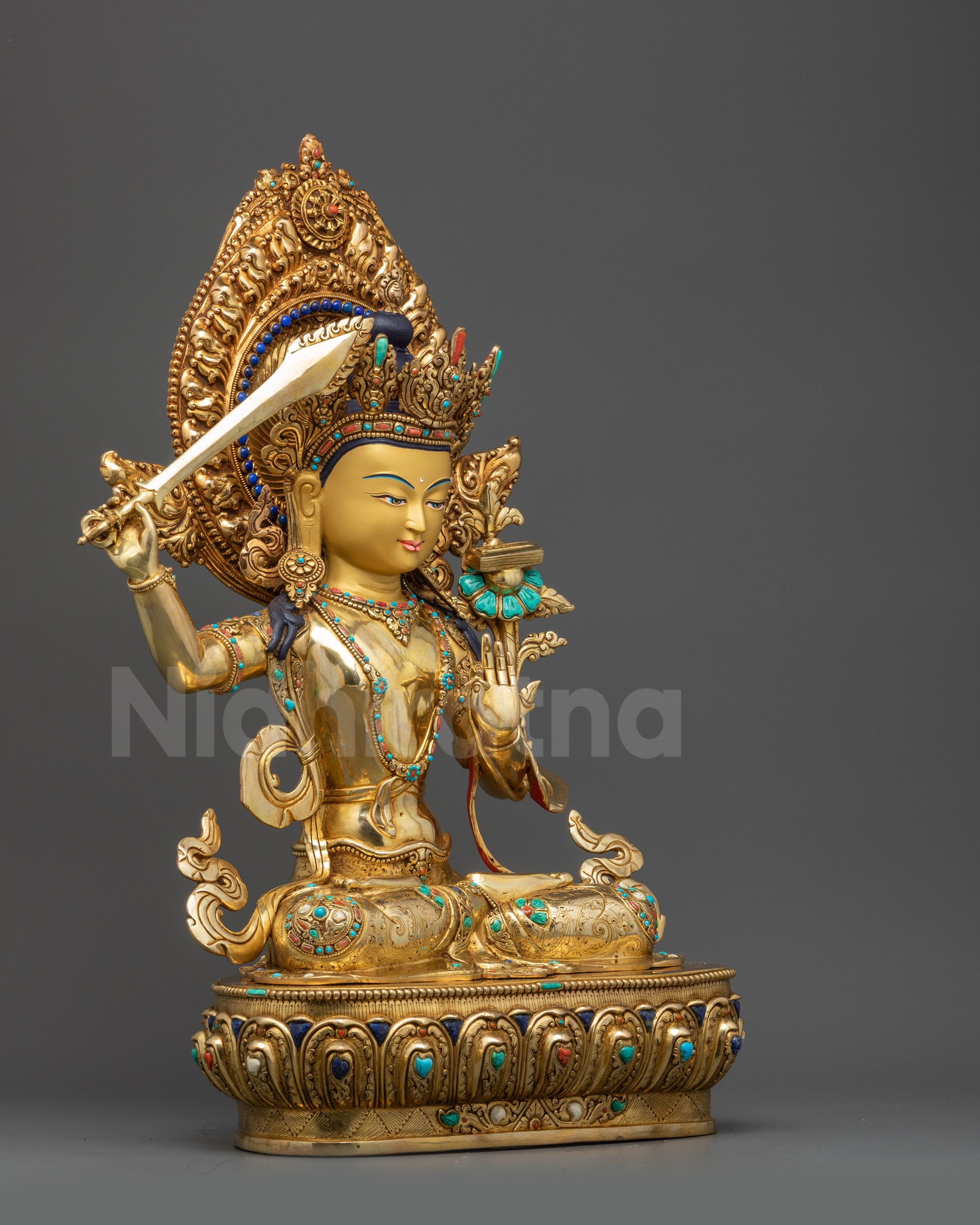 Right view side Manjushri Statue seated on lotus base with sword of wisdom and utpala flower