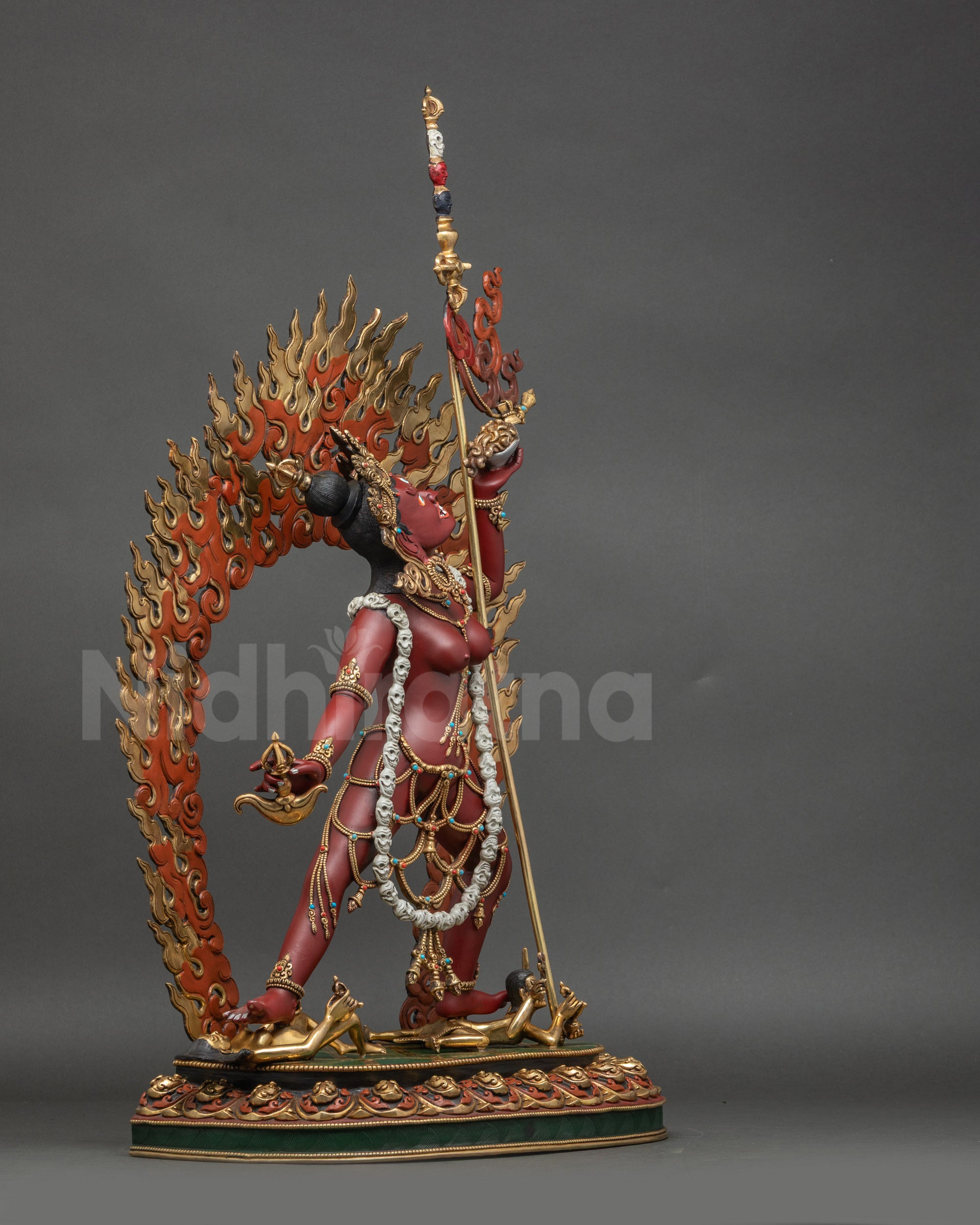 Right view side Vajrayogini Dakini statue standing on lotus over subdued figures