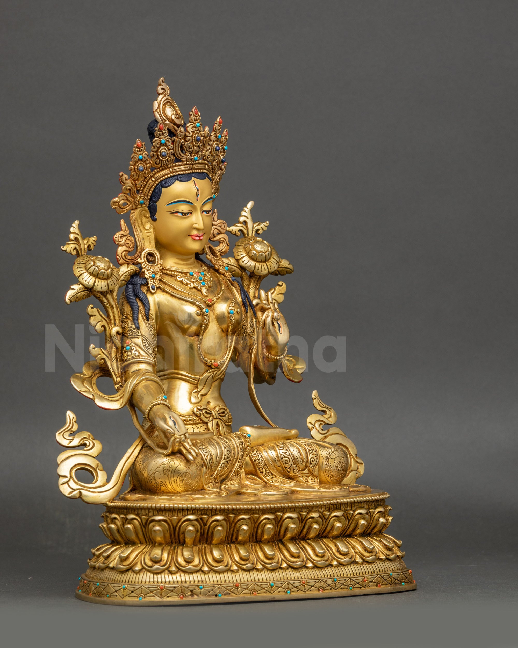 Right view side White Tara sculpture showing carved patterns on the lotus seat and the robe