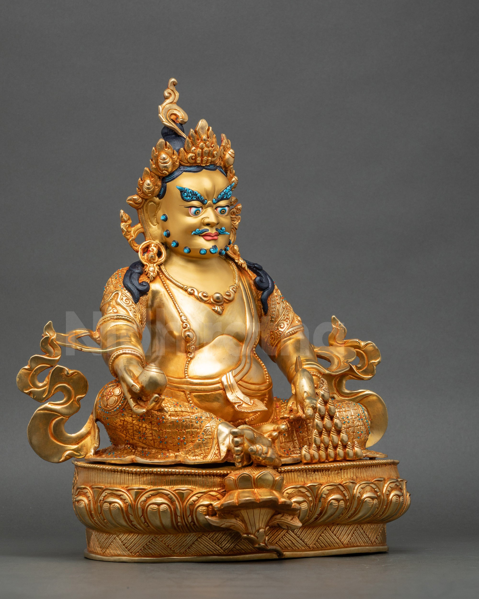 Right view side of Dzambhala Statue seated on lotus base with patterned garments