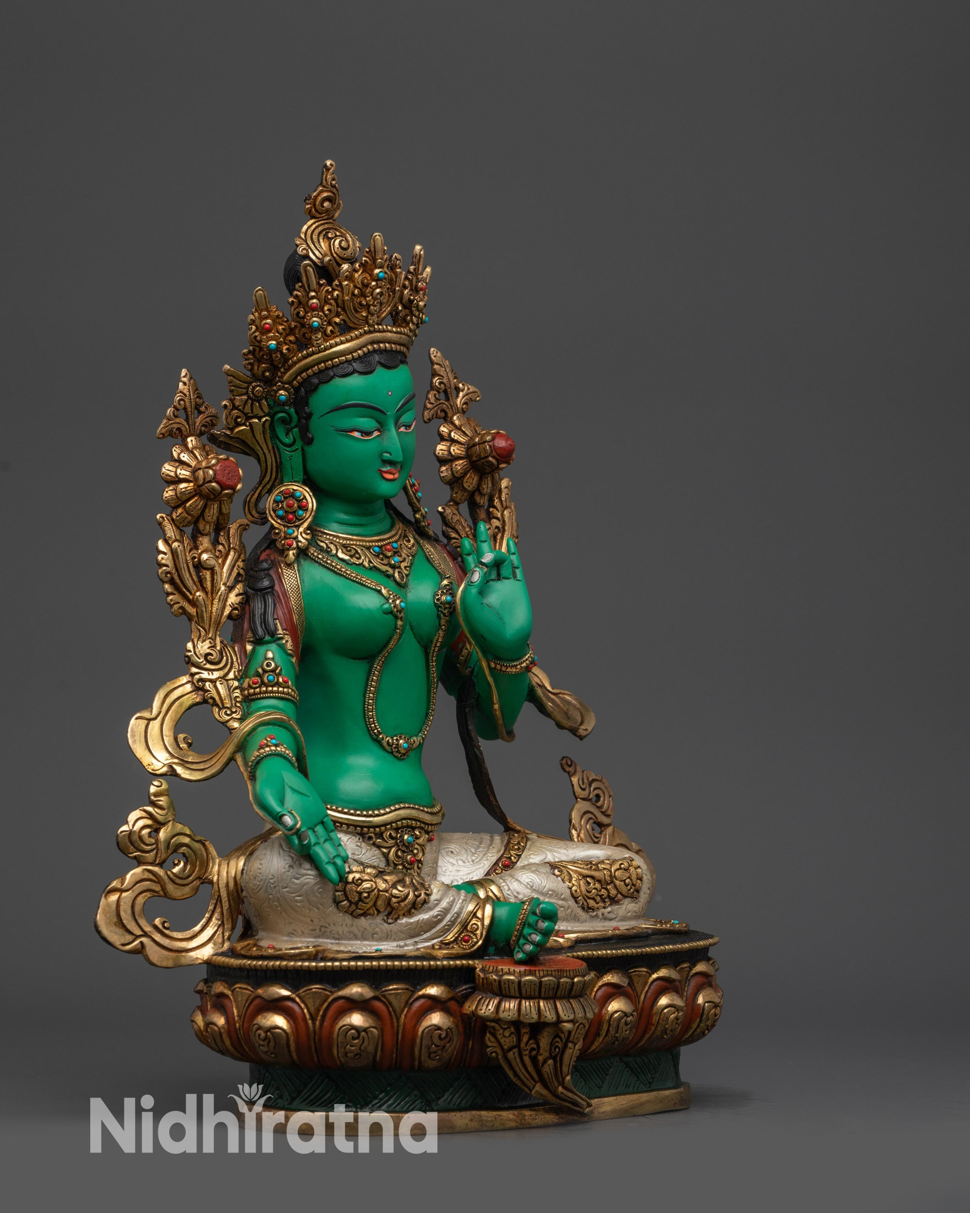 Right view side of Green Tara statue with gold-plated robe and floral motifs
