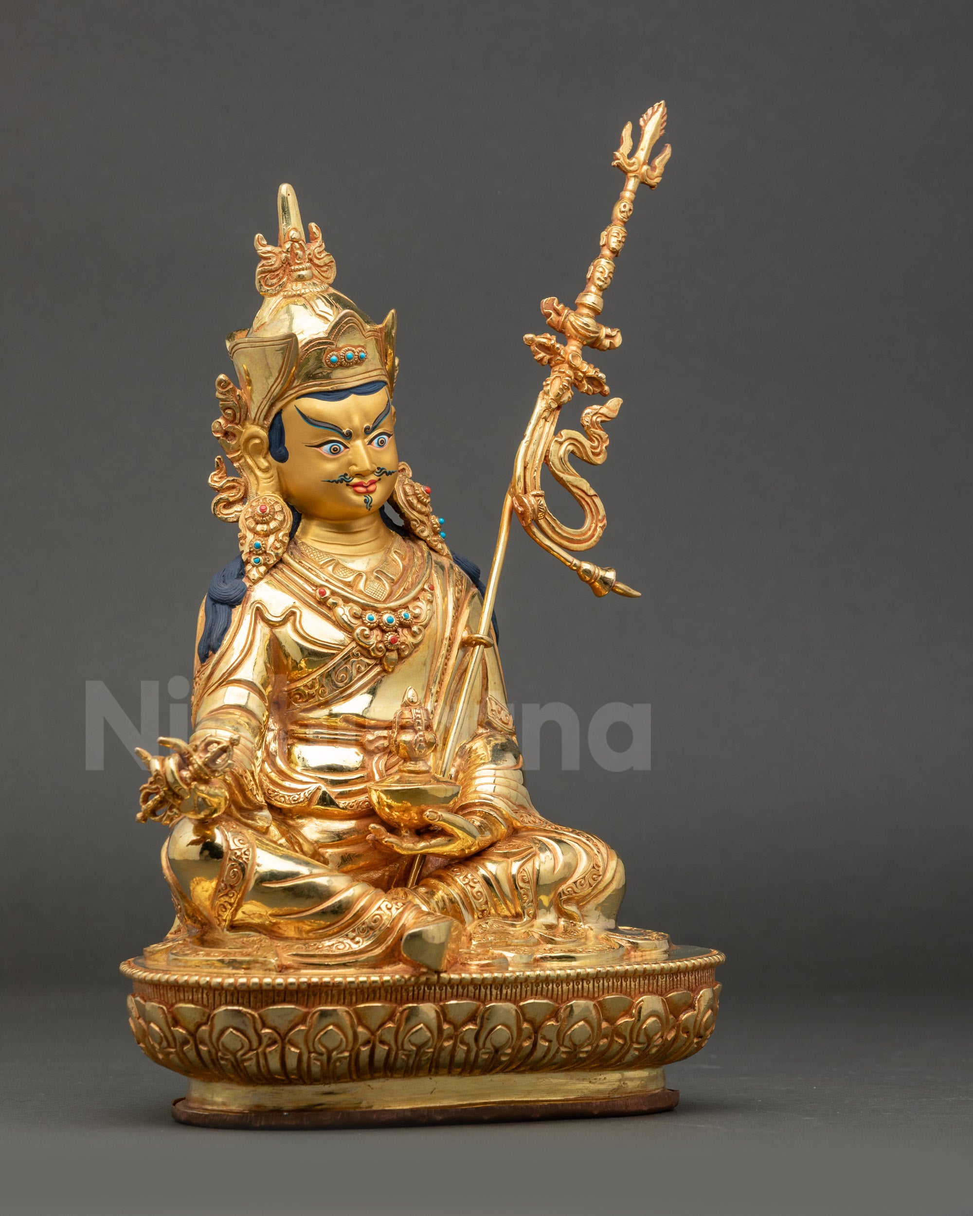 Right view side of Guru Rinpoche Statue displaying vajra and khatvanga