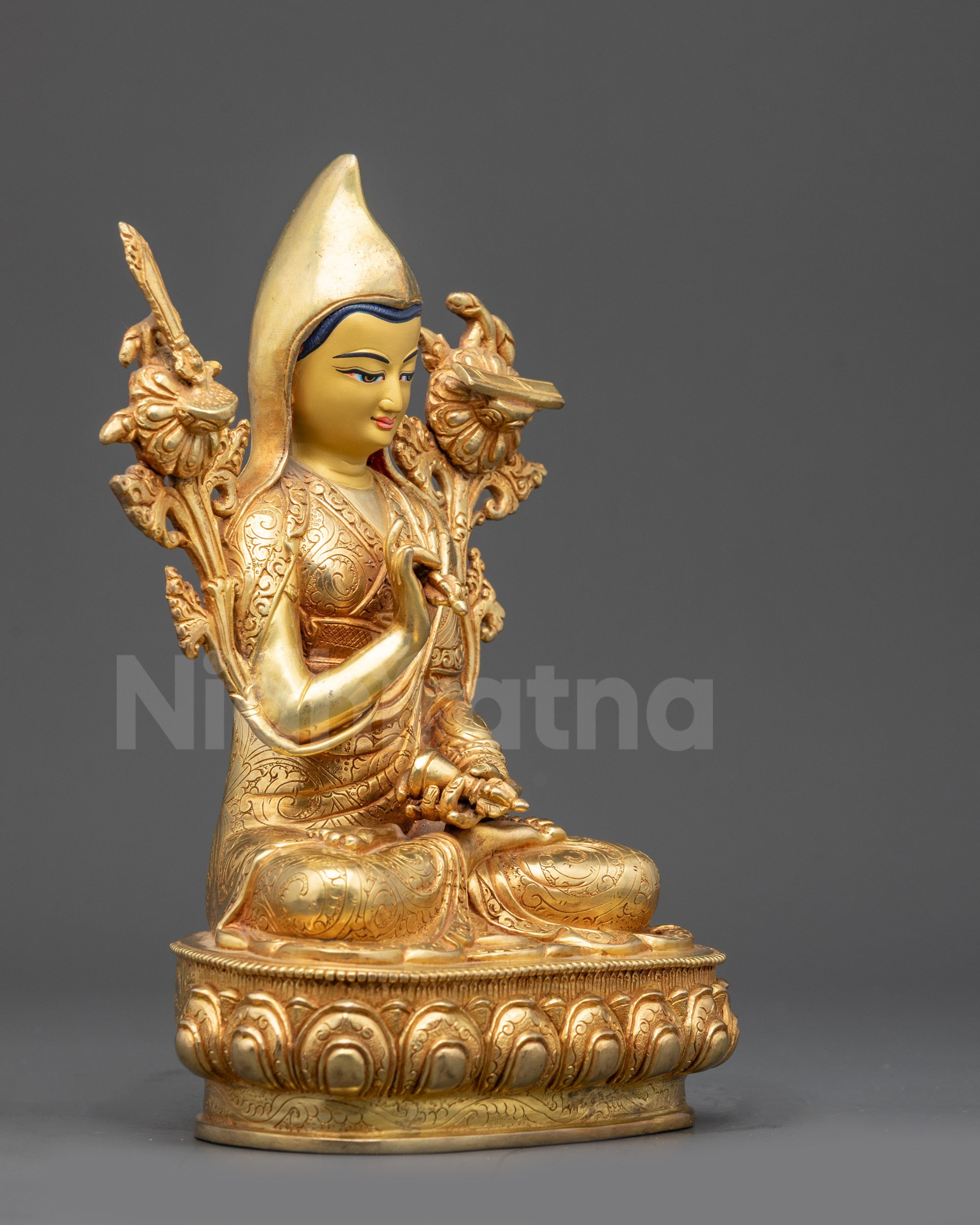 Right view side of Longchenpa statue showing vajra, bell, and lotus seat details