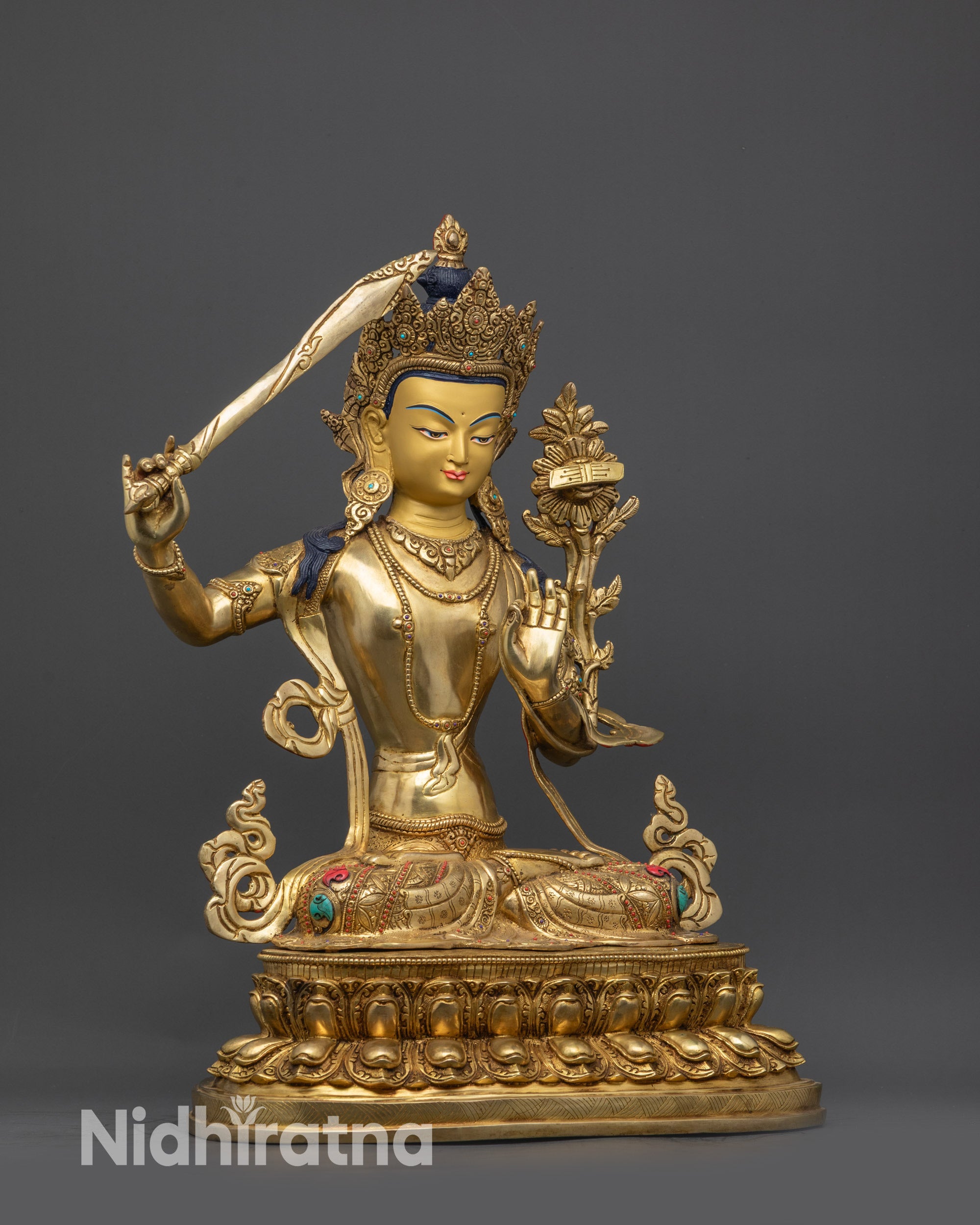 Right view side of Manjushri statue showing gold-gilded robes and lotus seat details