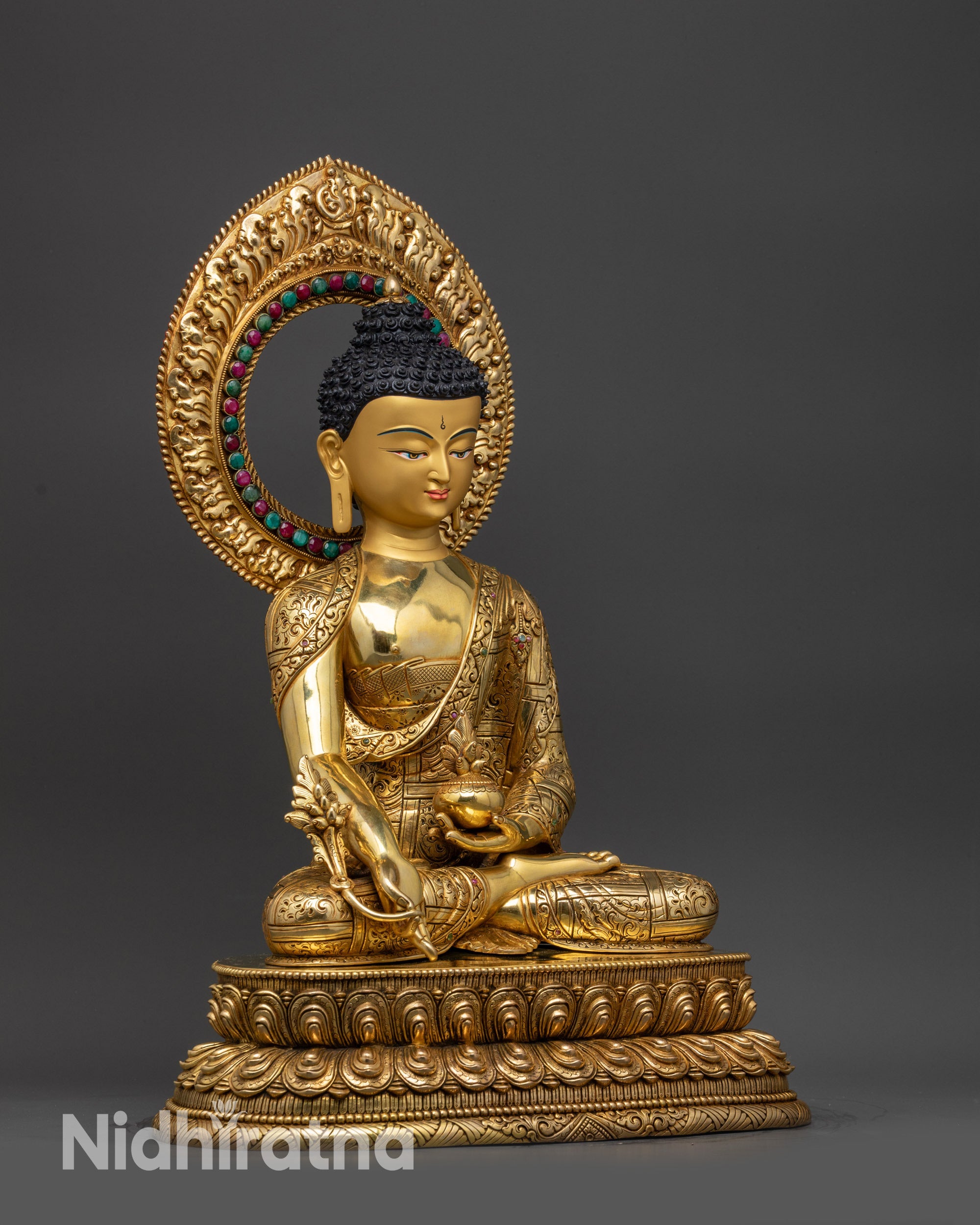 Right view side of Medicine Buddha statue with healing bowl and myrobalan stem