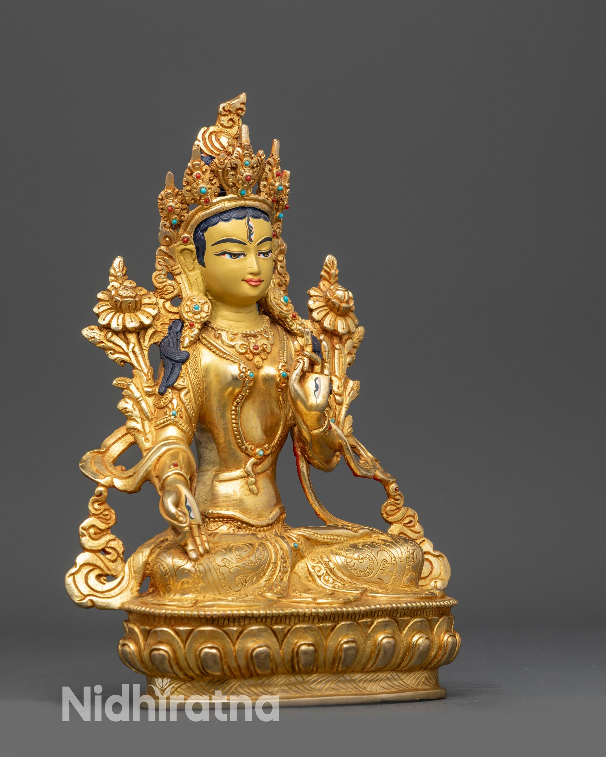 Right view side of White Tara statue displaying Varada and Vitarka mudra hands