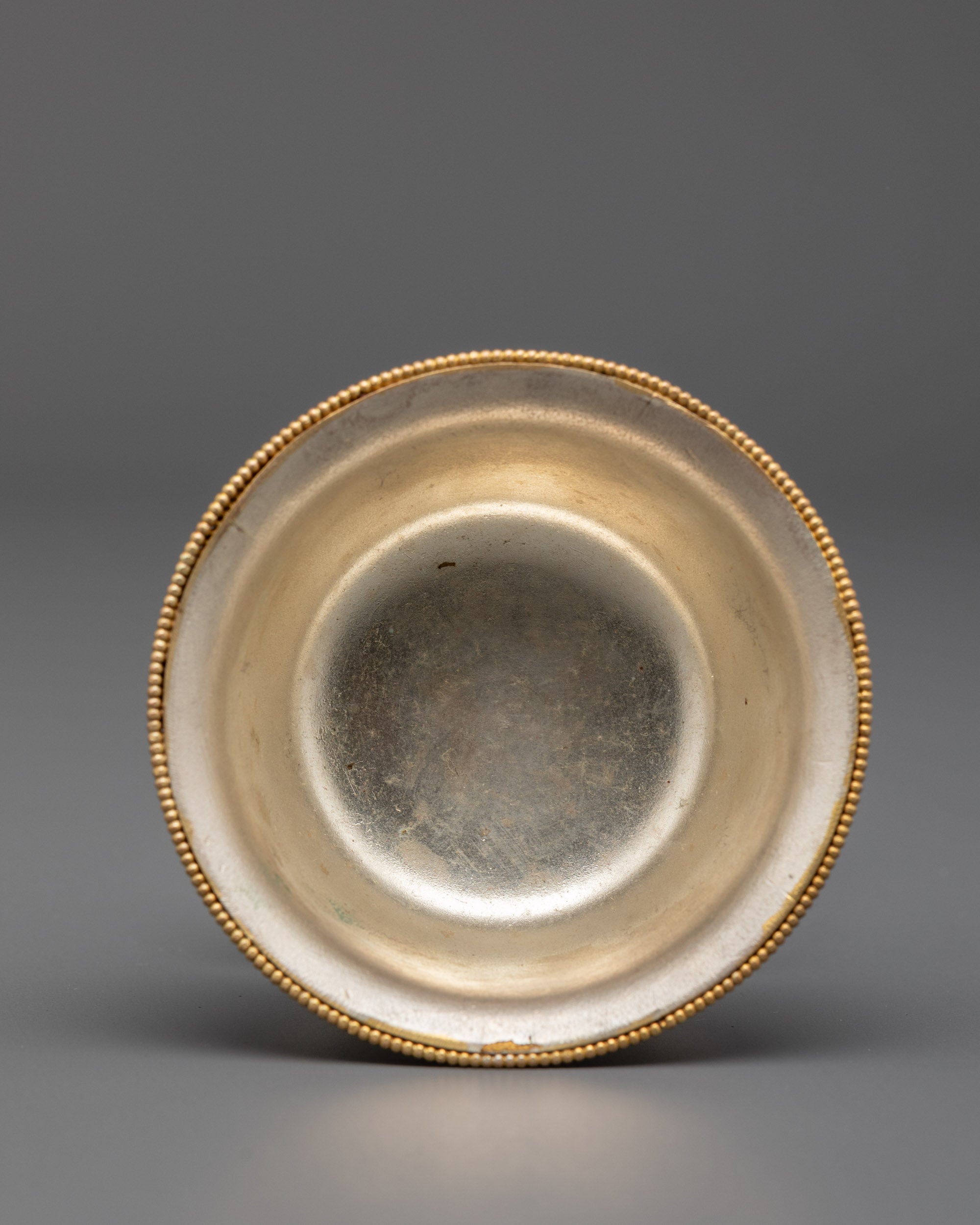 Tilted stacked bowls showing gold filigree patterns and semi-precious stone accents