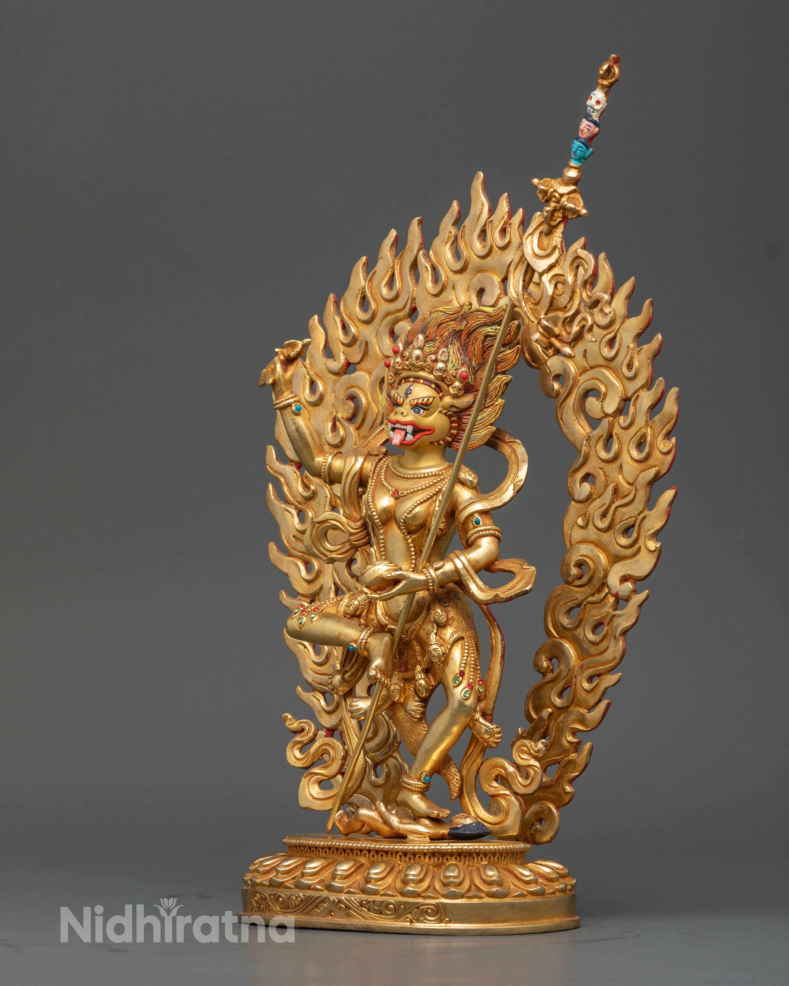 Side angle of 24k gold Simhamukha Statue with vibrant acrylic hand-painted ornaments
