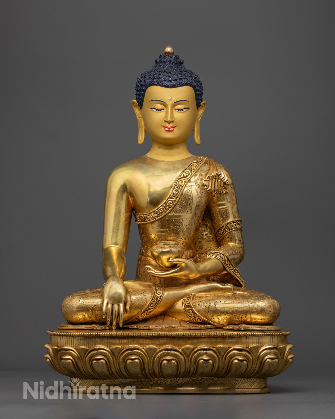 Sacred Shakyamuni Buddha Statue – handcrafted Tibetan artwork with detailed sanghati robe and gold-gilded face.