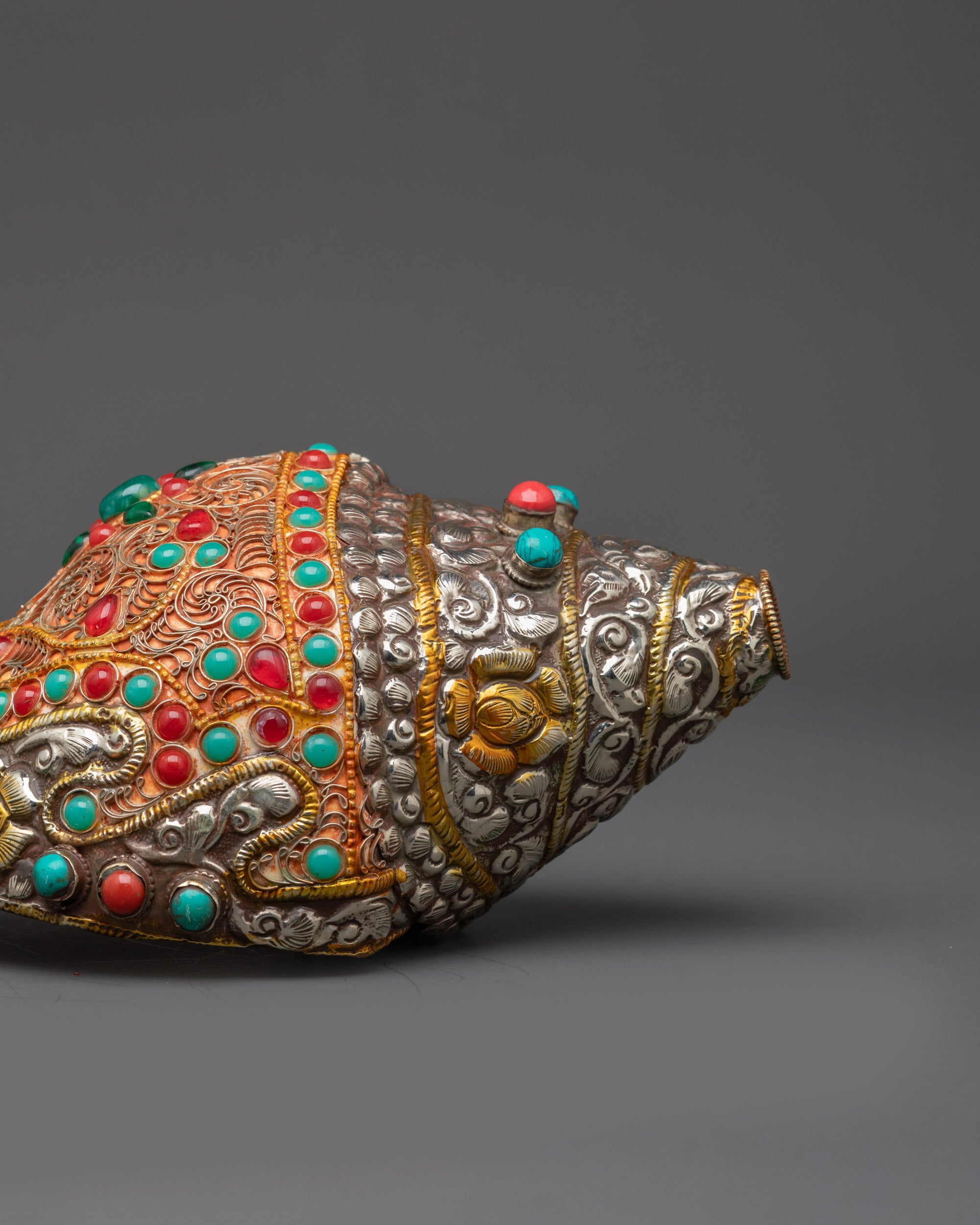 Sacred Shankh made of copper adorned with ruby, emerald, turquoise, and coral inlays