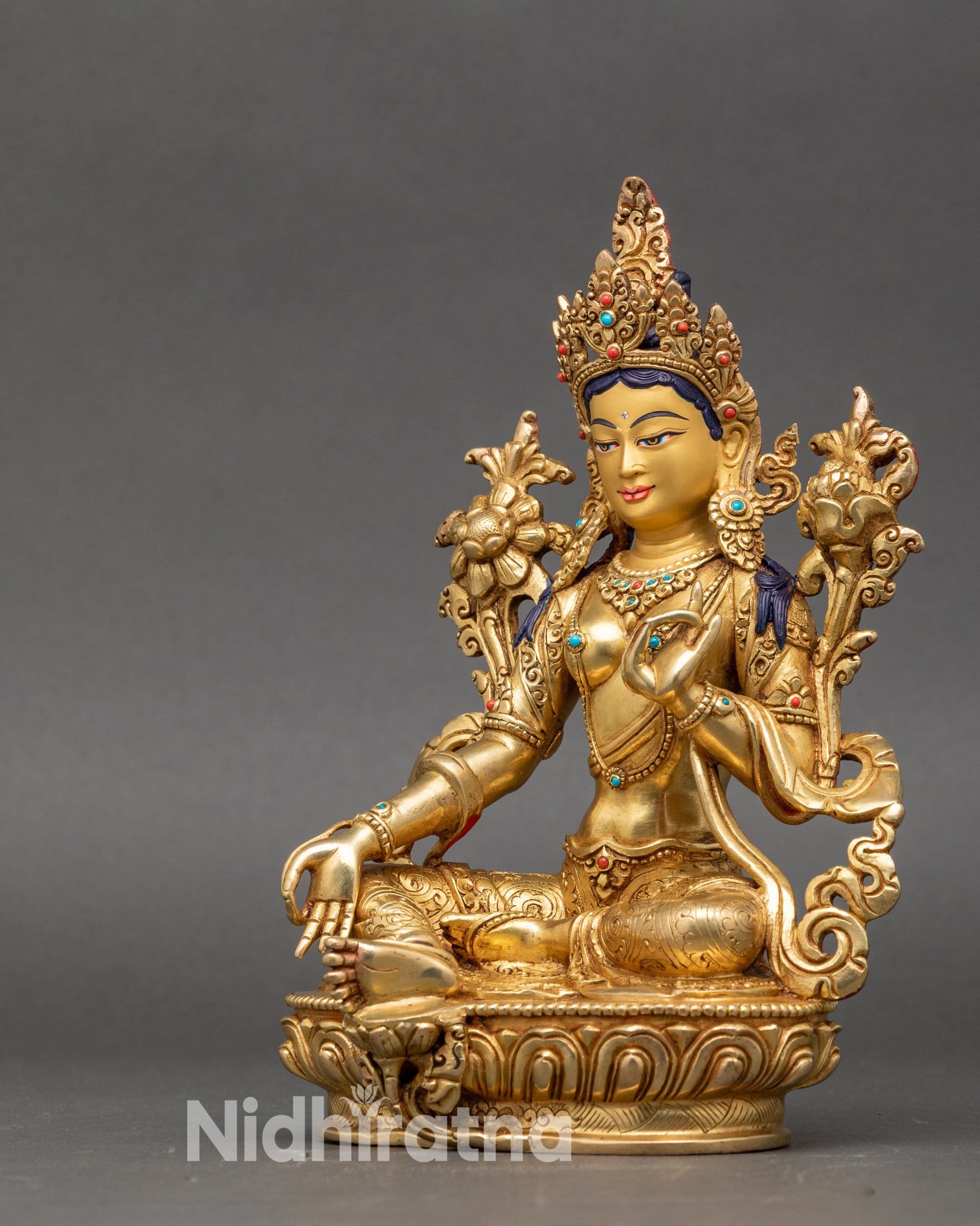 Sacred Tara left side showing utpala flower and intricately carved floral garments