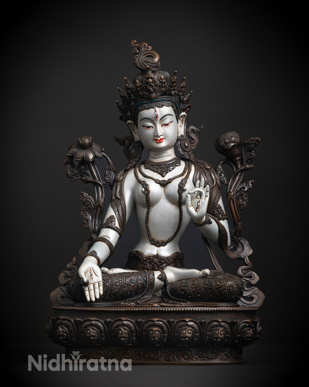 White Tara's serene face and jeweled crown, showcasing intricate craftsmanship and traditional Tibetan artistry.