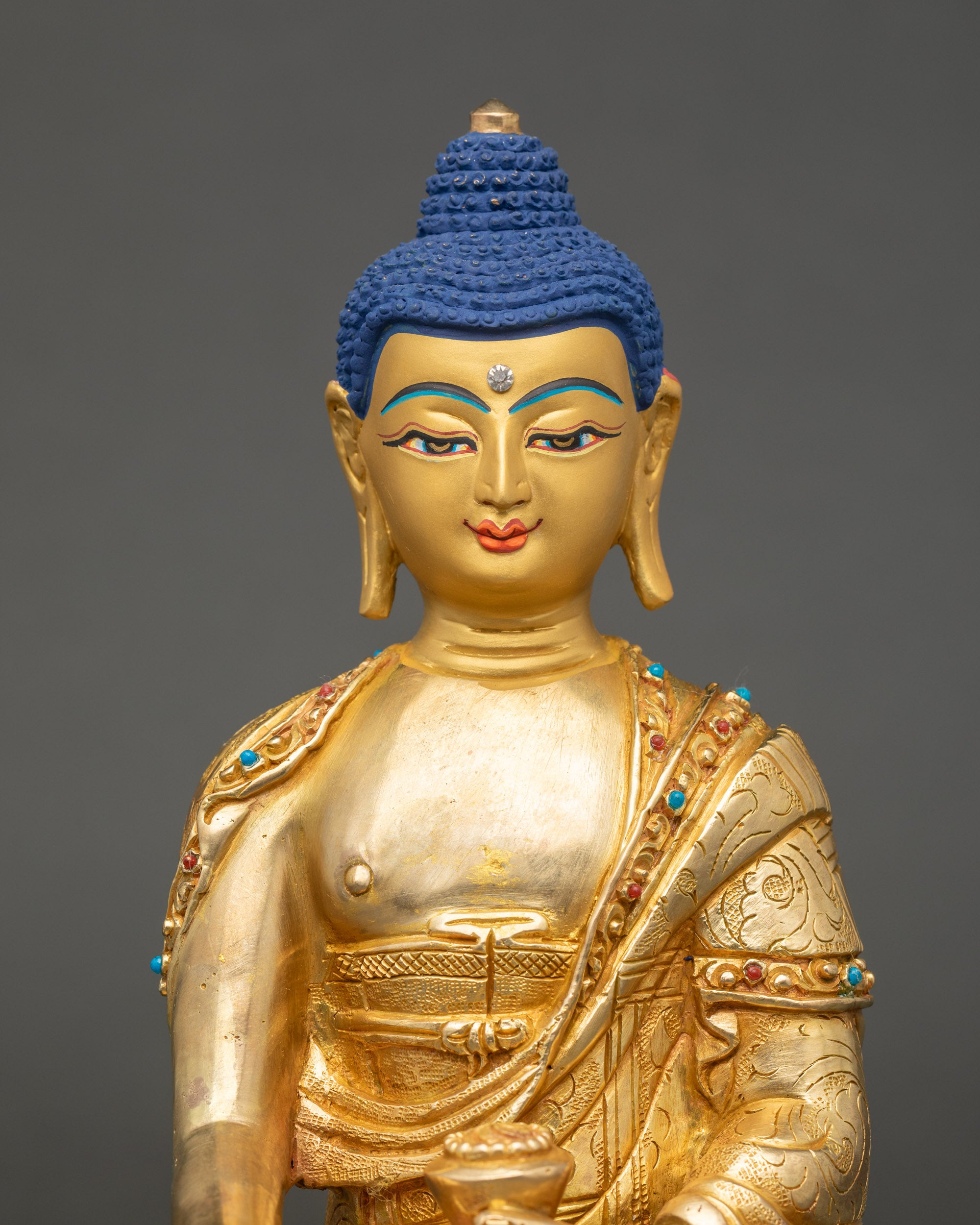 Sakyamuni Buddha Statue close up showing gold face and intricate carvings