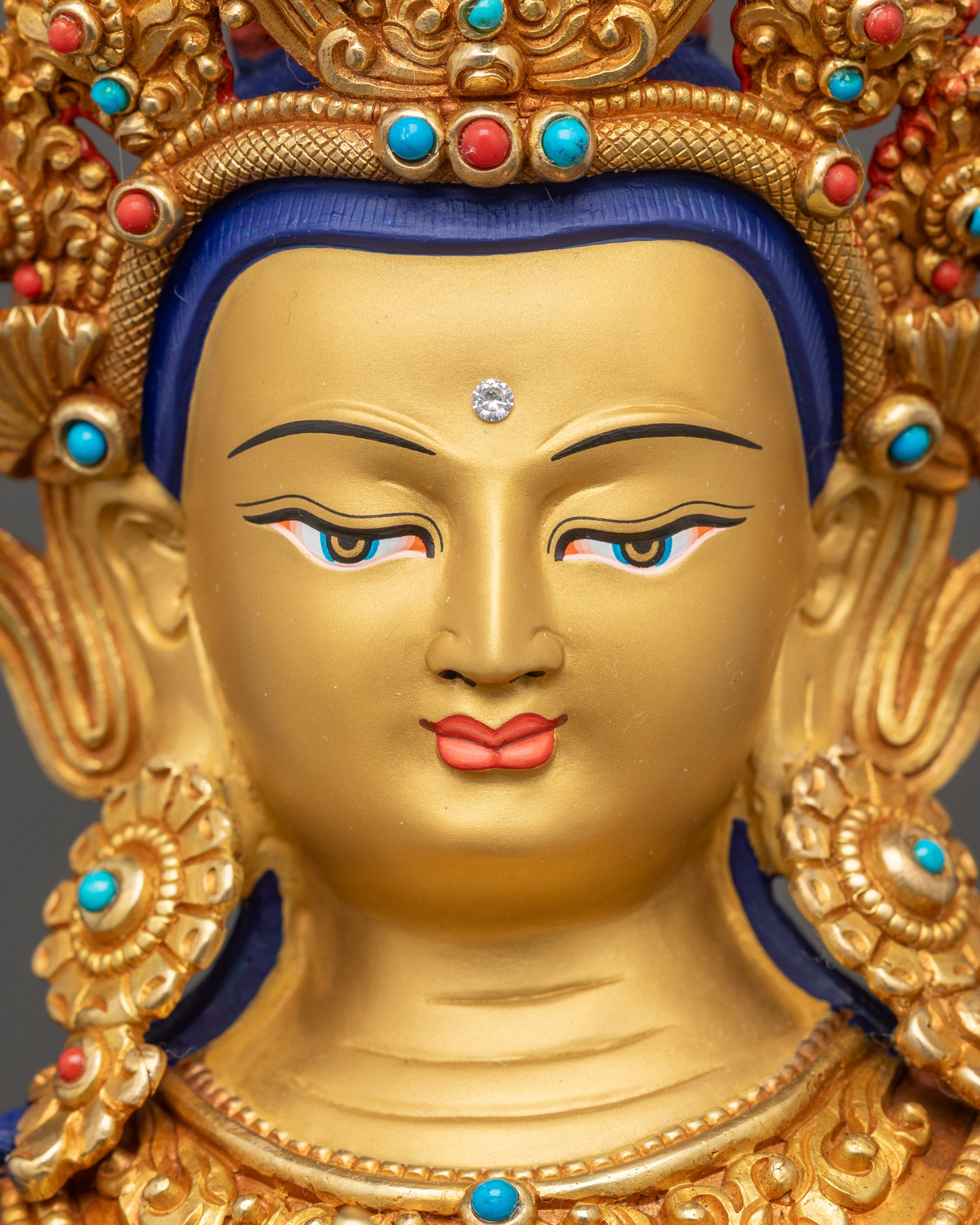 Samantabhadra gold-gilded face with serene expression and jeweled crown