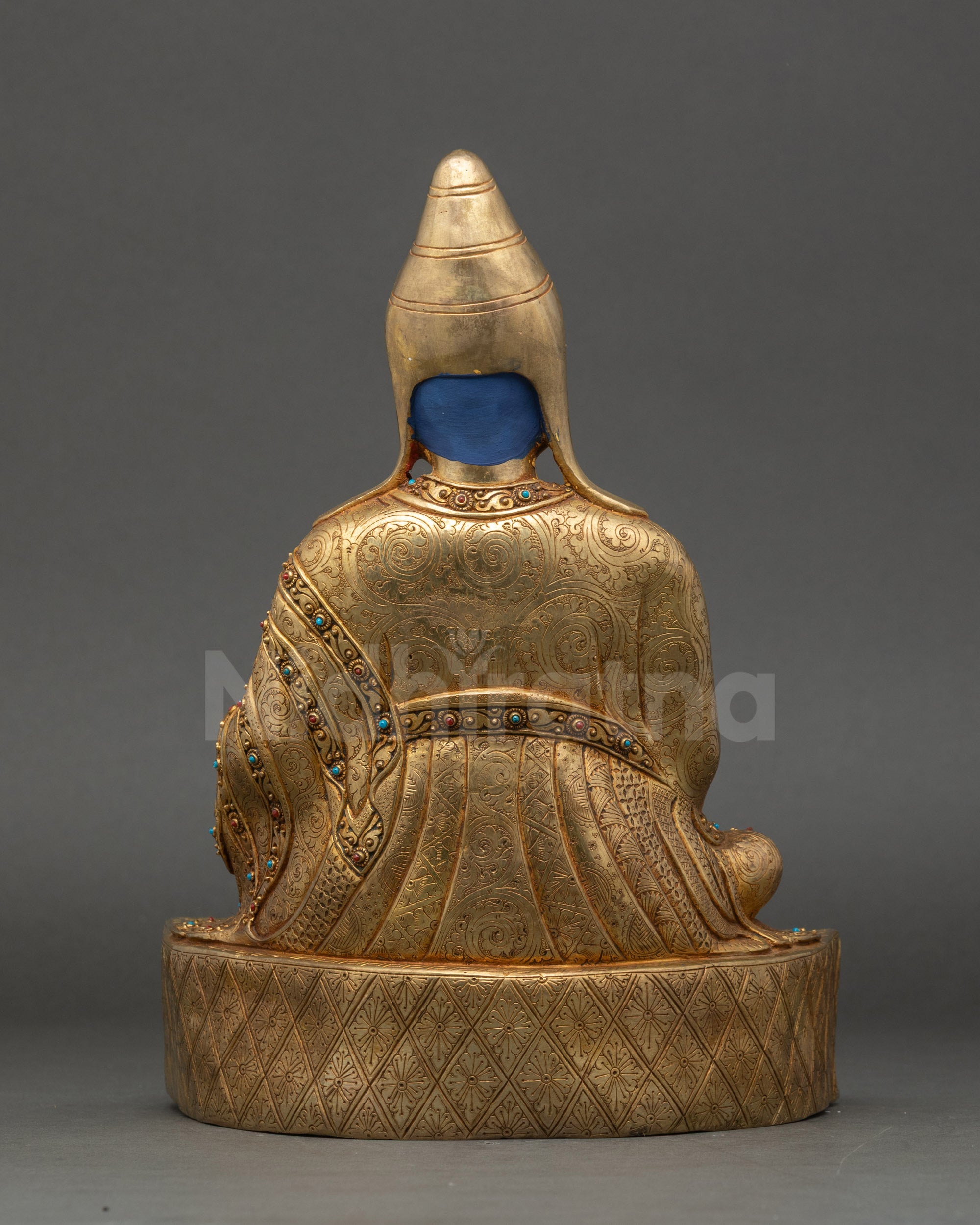 Santaraksita statue back view carved monastic robes and pedestal