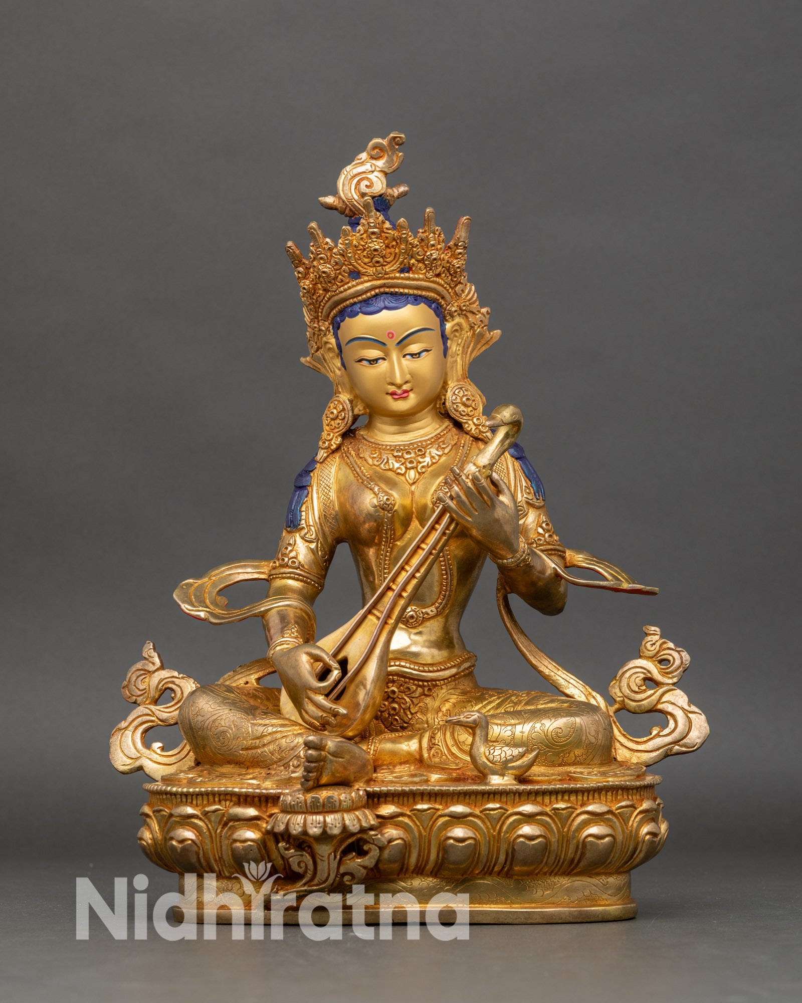 Saraswati statue seated on lotus with veena, copper and gold fire gilded Nepalese artwork