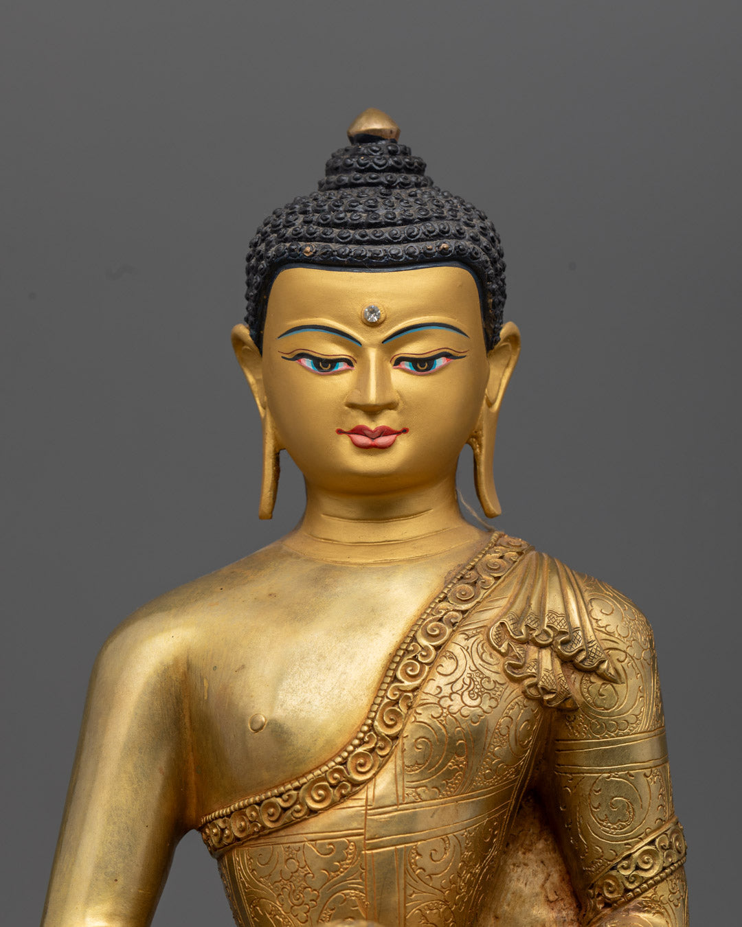 Serene face of Amitabha Buddha statue with intricate gold gilding and turquoise-inlaid eyes, radiating infinite light and compassion