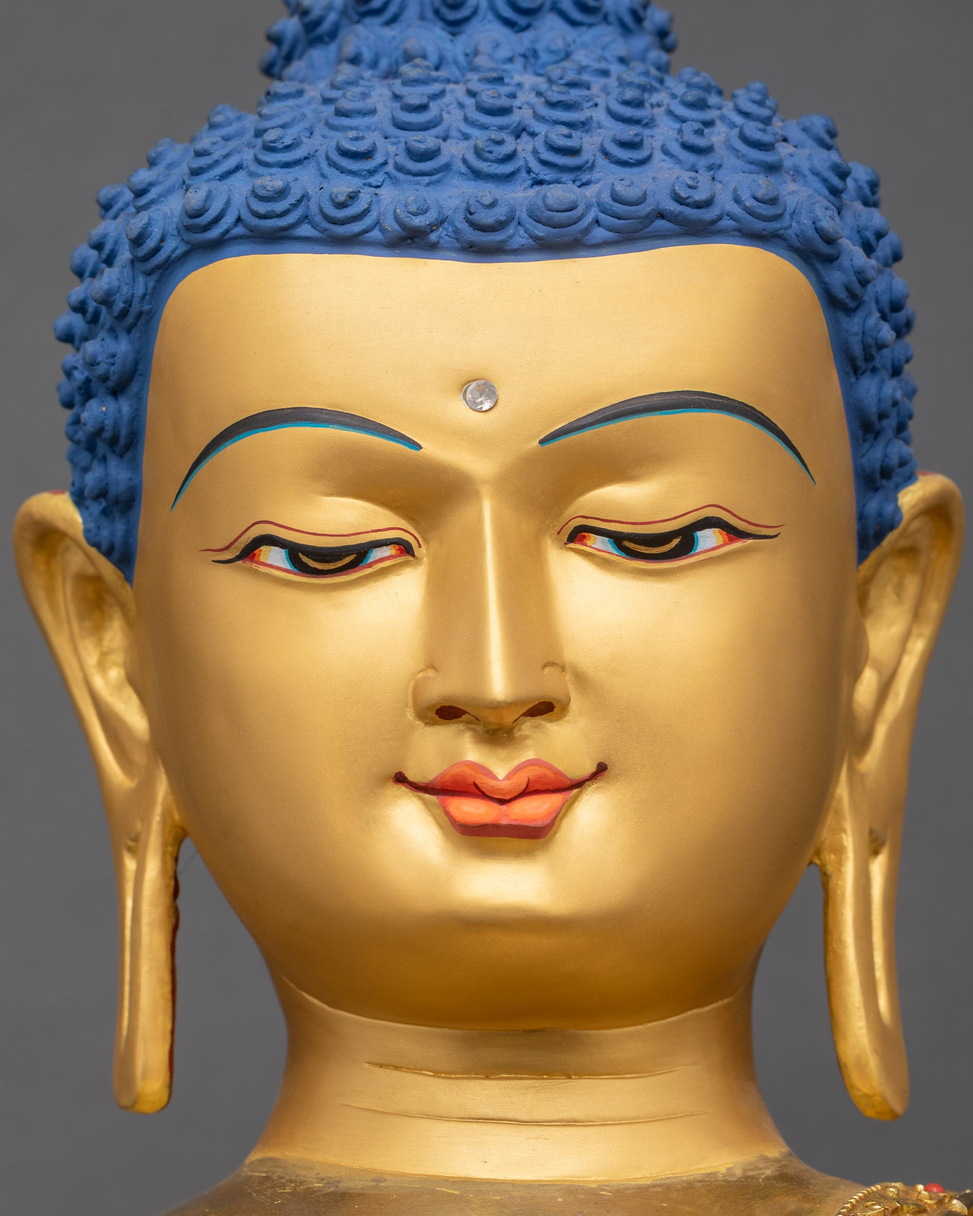 Serene golden Buddha face with peaceful expression framed by ornate turquoise-studded halo