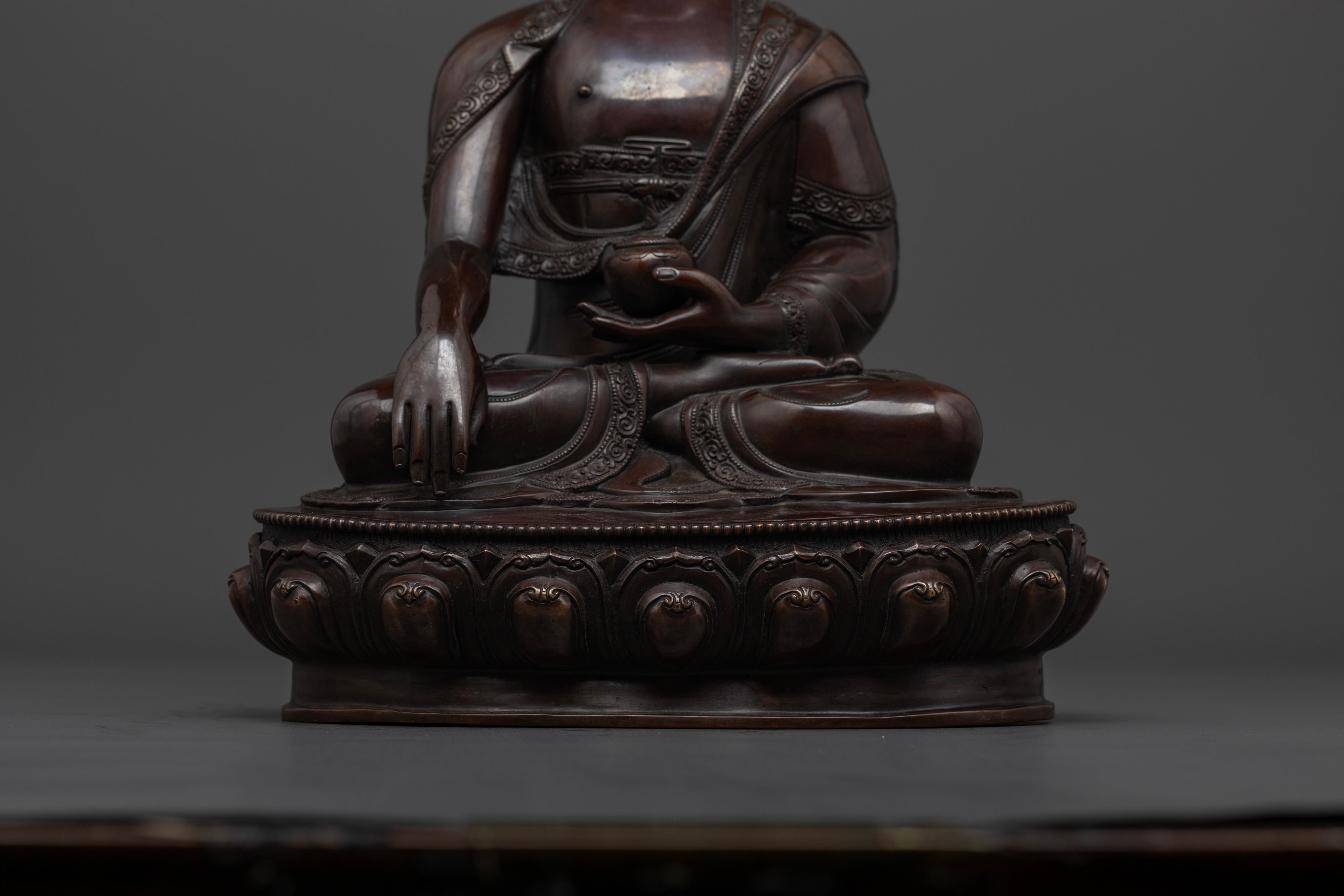 Shakyamuni Buddha statue holding his alms bowl with Bhumisparsha Mudra