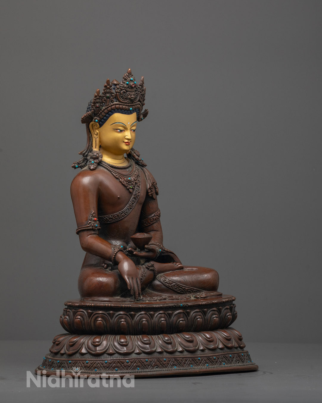Side angle showing monk’s robe and alms bowl in earth-touching mudra, oxidized finish