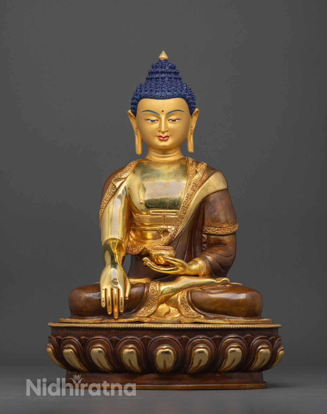Front view of handcrafted Buddha Shakyamuni Tibetan statue on lotus throne