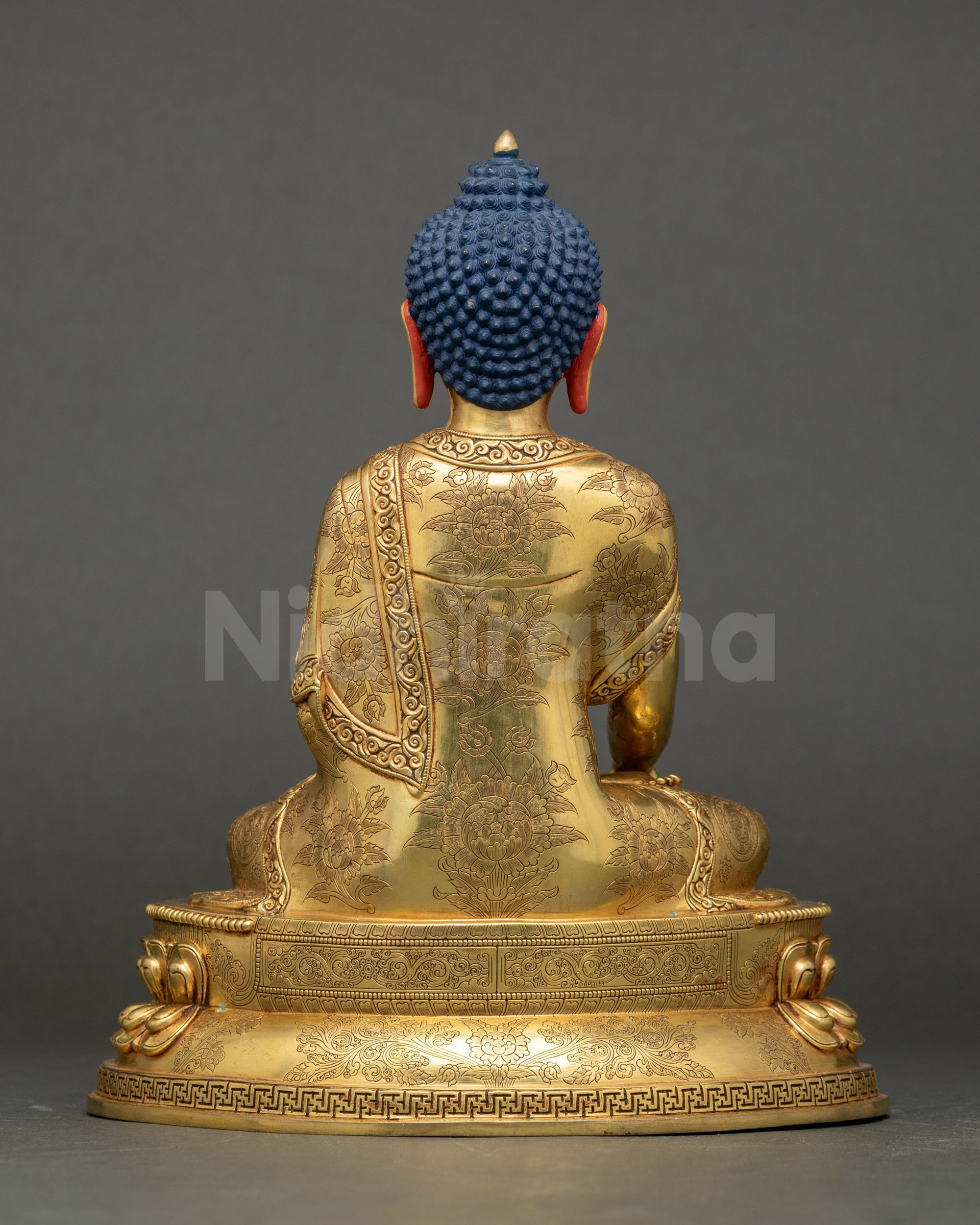 Back view showing carved robes and double-layered lotus seat of Buddha statue.