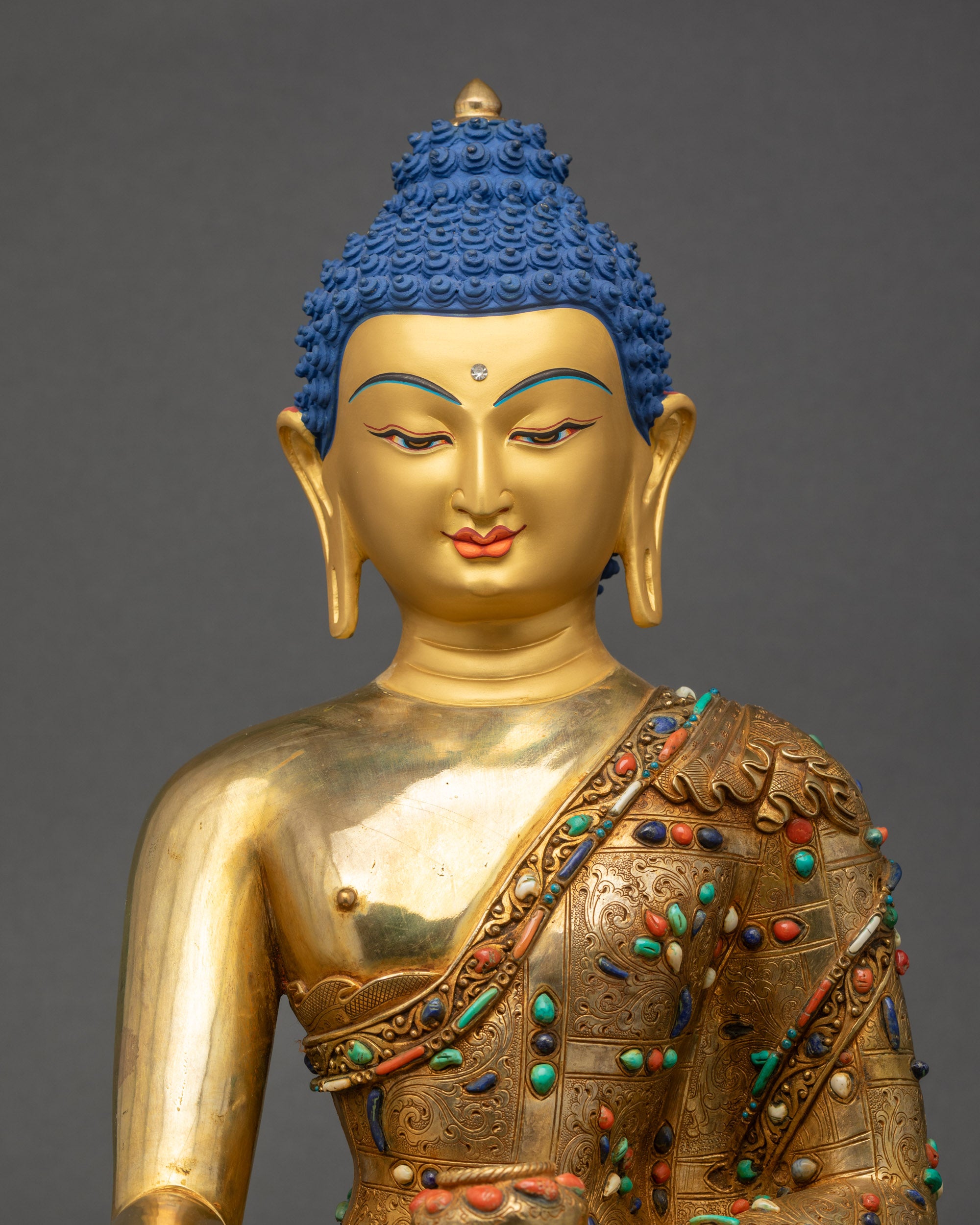 Close-up of Shakyamuni Buddha statue highlighting detailed robe and copper alloy
