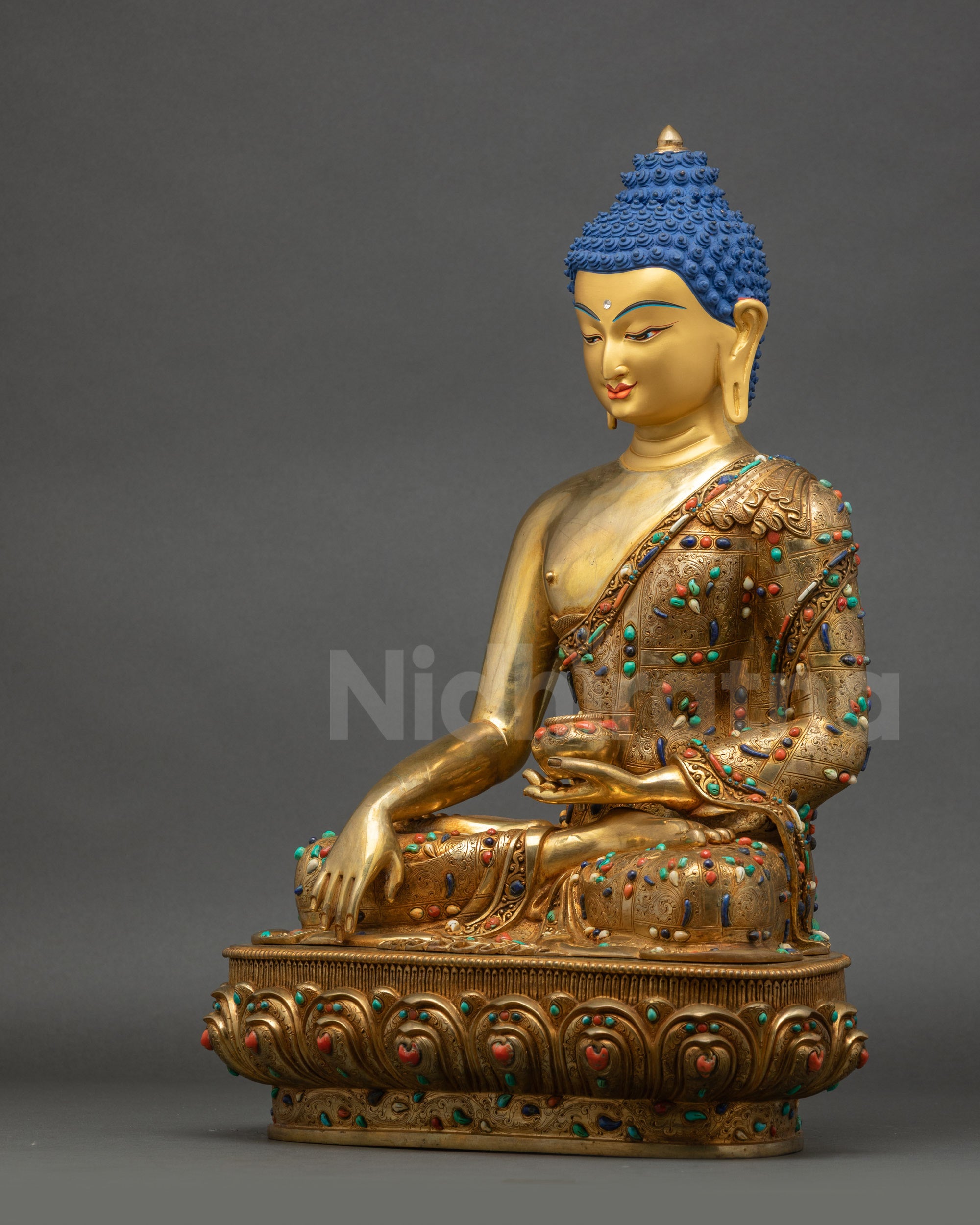 Left side view of Shakyamuni Buddha statue displaying intricate robe and serene posture