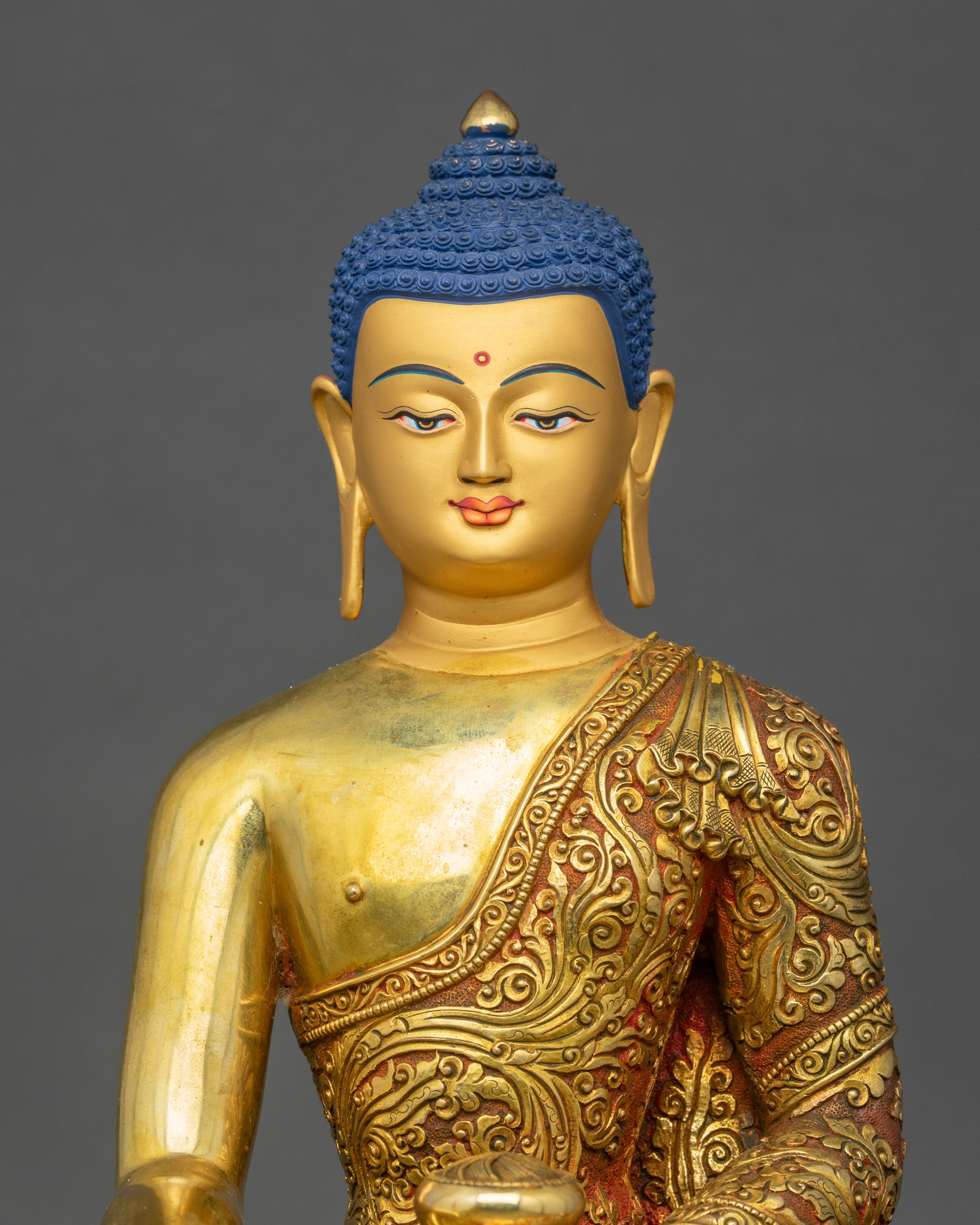 Shakyamuni Buddha copper statue gold-painted face close up meditation art