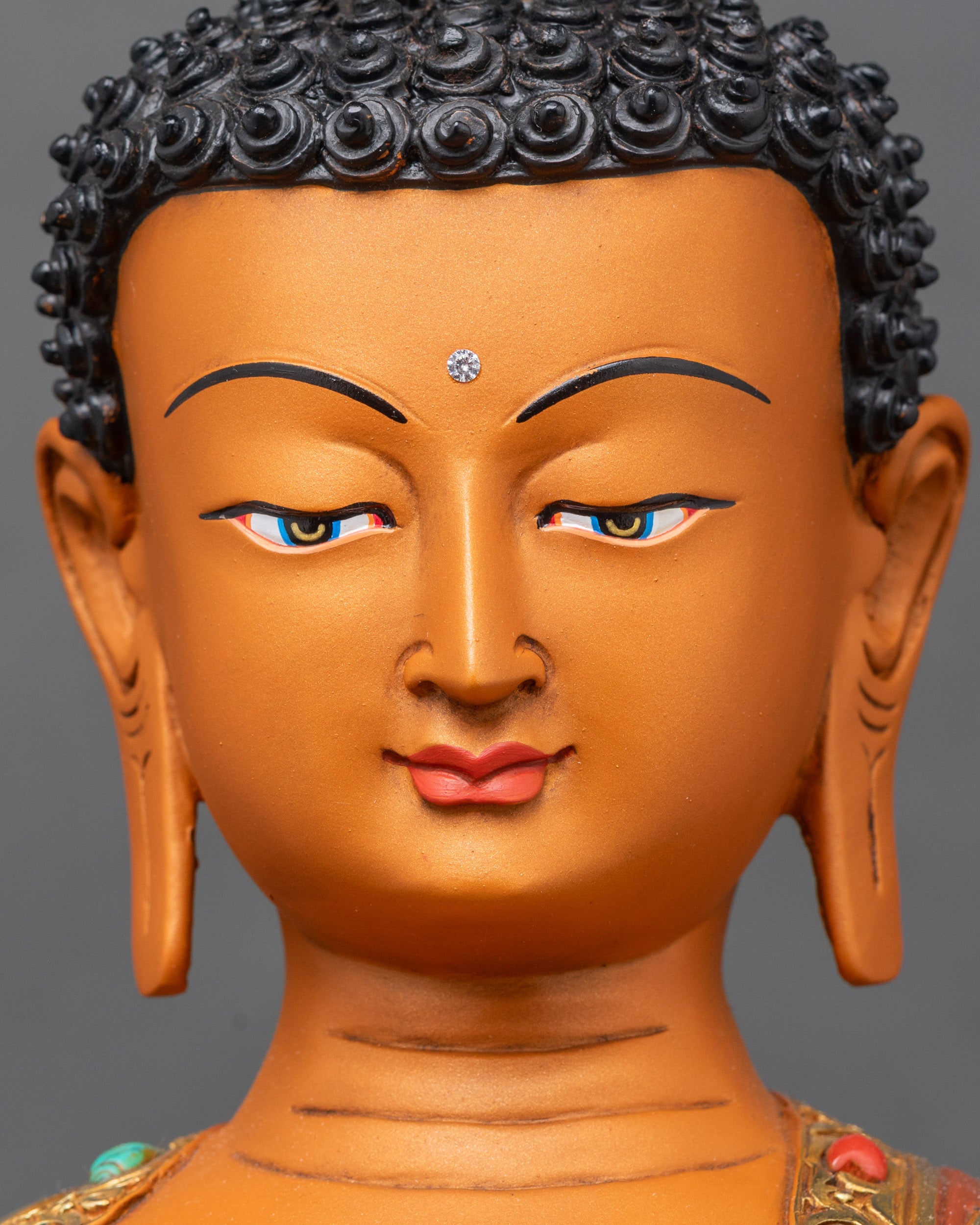 Shakyamuni Buddha face with serene expression, gold fire-gilded and semi-precious stones